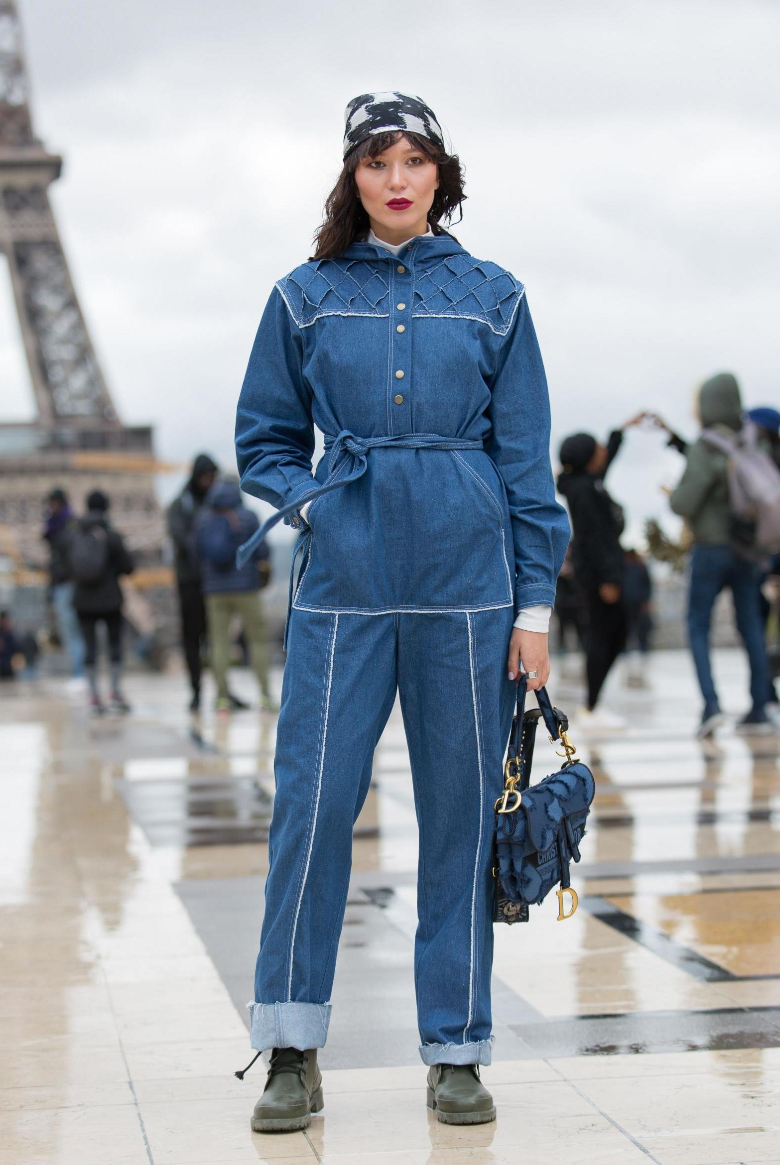 This fashion week guest kept things casual in a denim boiler suit that featured visible, decorative sticking and a tie waist. She accessorised with a black-and-white bandana and a denim Dior bag.
