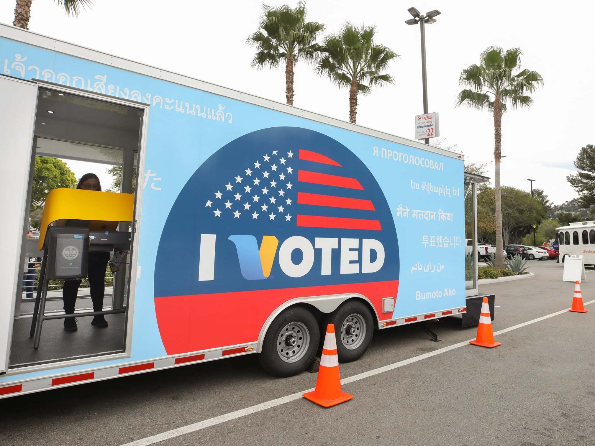 A voter prepares her ballot in a voting booth during early voting for the California presidential primary election