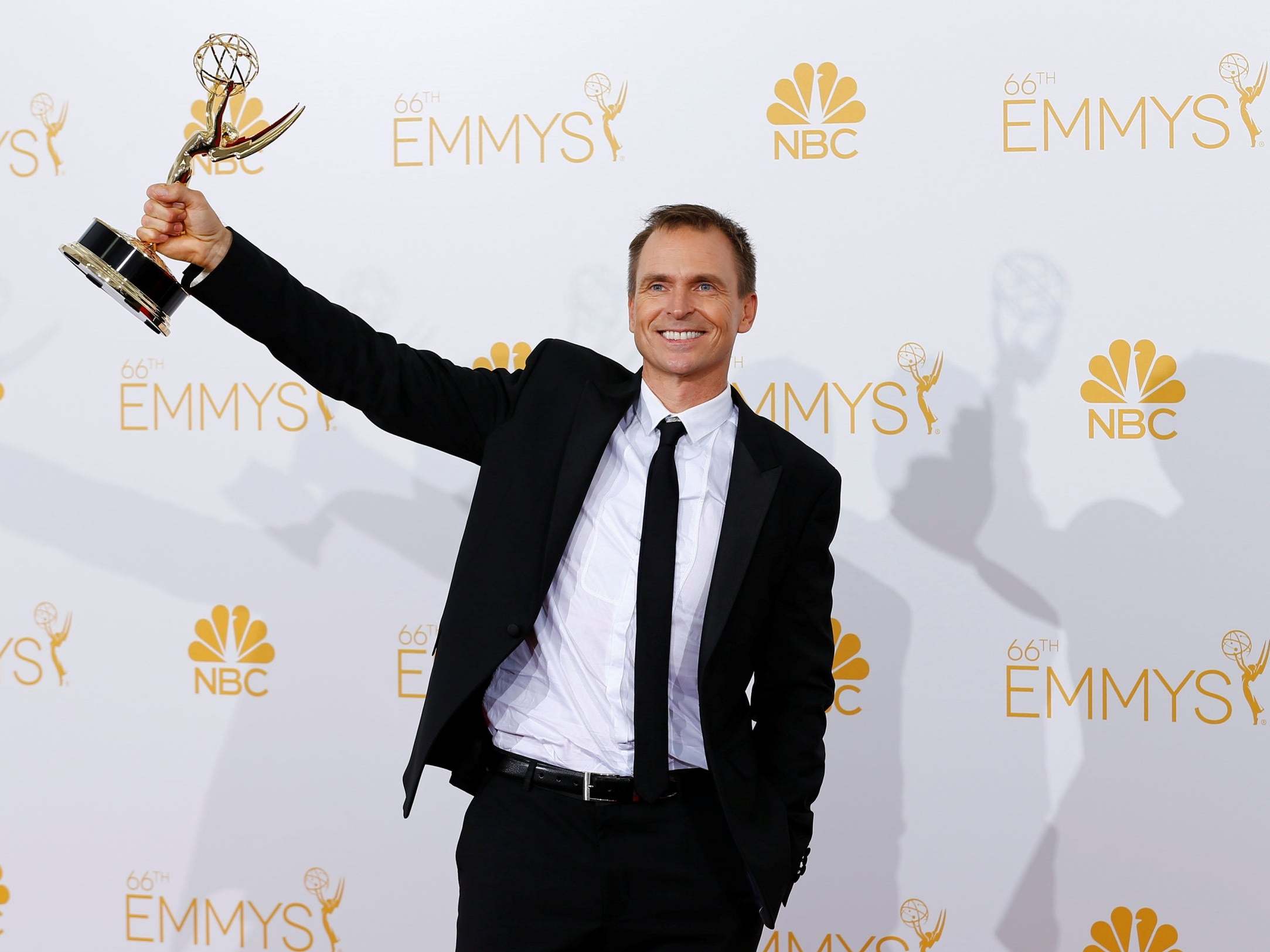 Phil Keoghan poses with his Outstanding Reality-Competition Program award for the CBS show