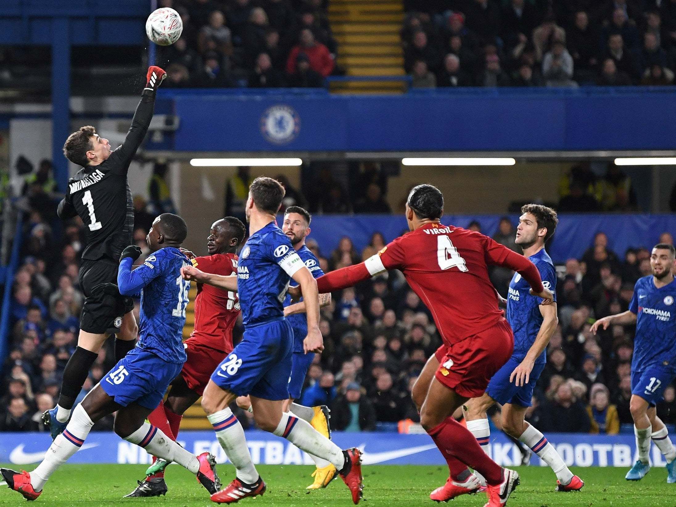Kepa Arrizabalaga punches the ball clear during a Liverpool attack