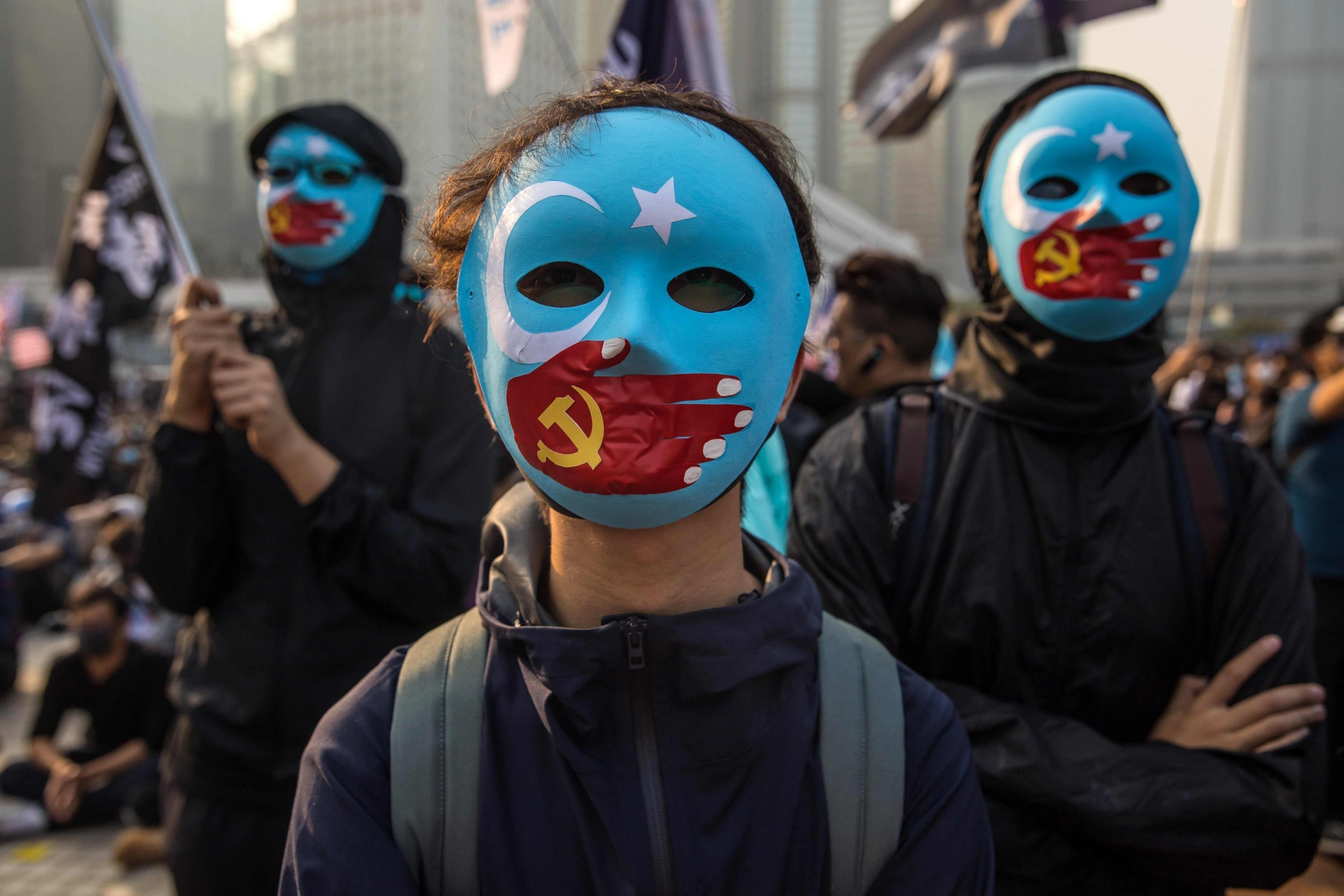 Protesters attend a rally in Hong Kong to show support for the Uighurs