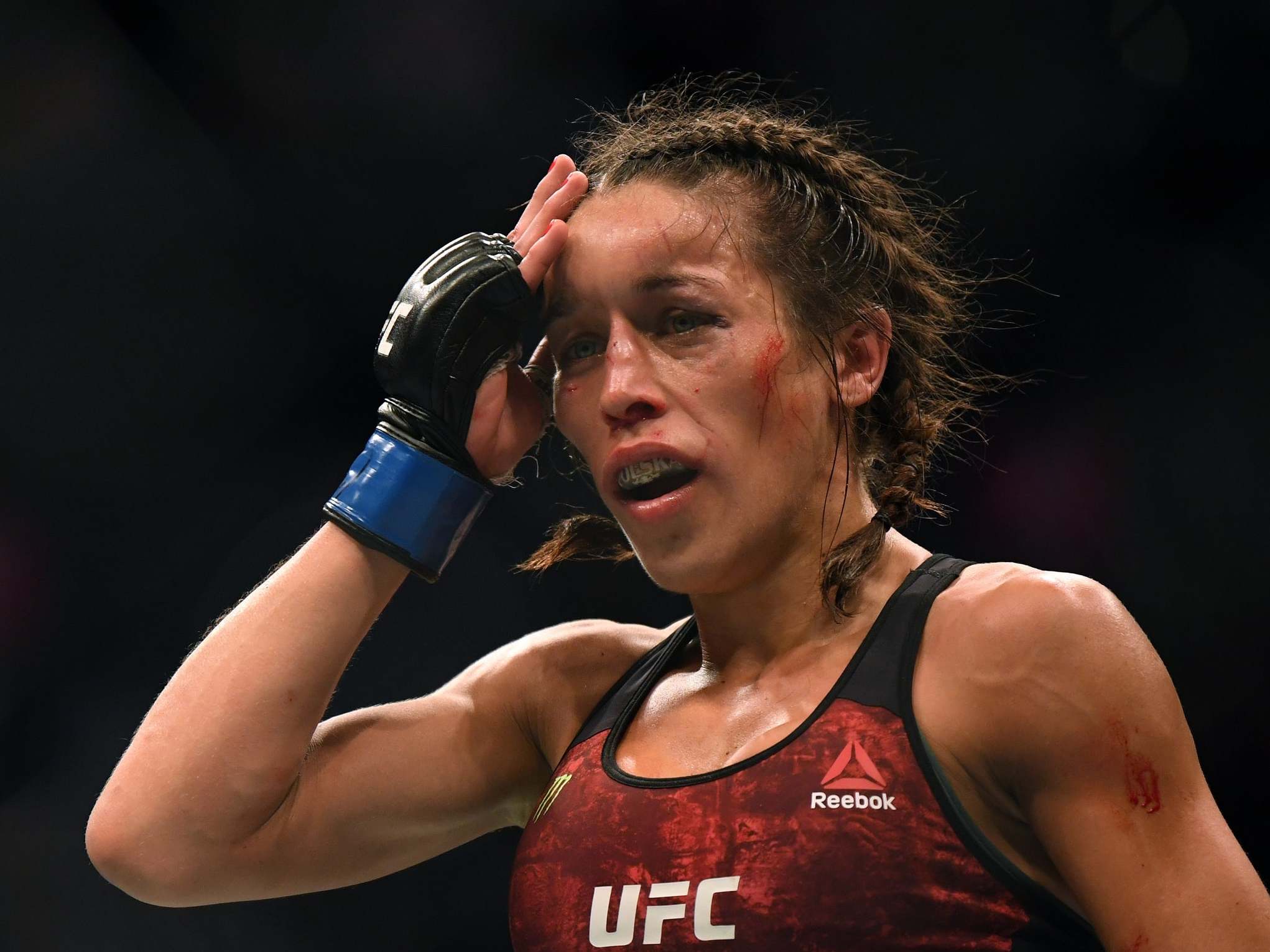 Joanna Jedrzejczyk feels her head after a punishing fight against Weili Zhang