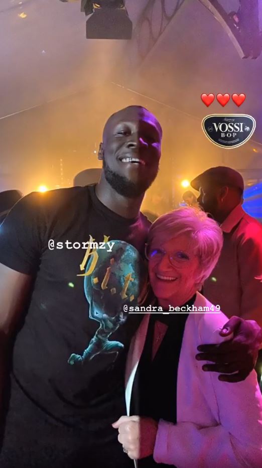Stormzy poses with David Beckham's Mum Sandra at Brooklyn's 21st birthday (Instagram )