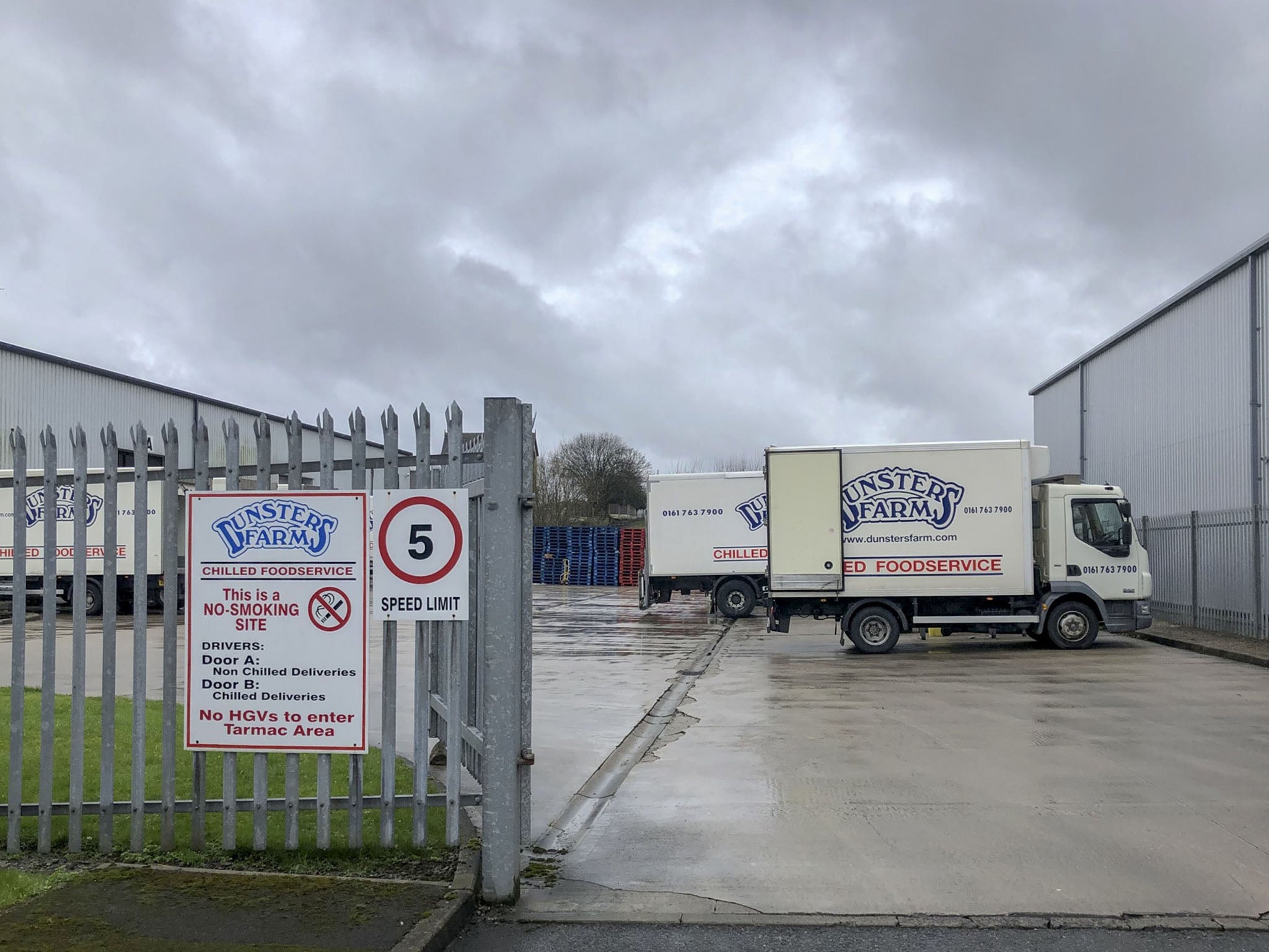 Vans sit parked at the Dunsters warehouse in Bury