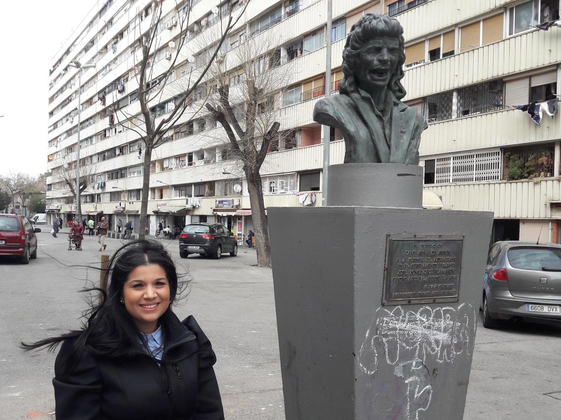 Susana Martinez Heredia standing next to a statue of Camaron de la Isla in La Mina (Graham Keeley/The Independent)