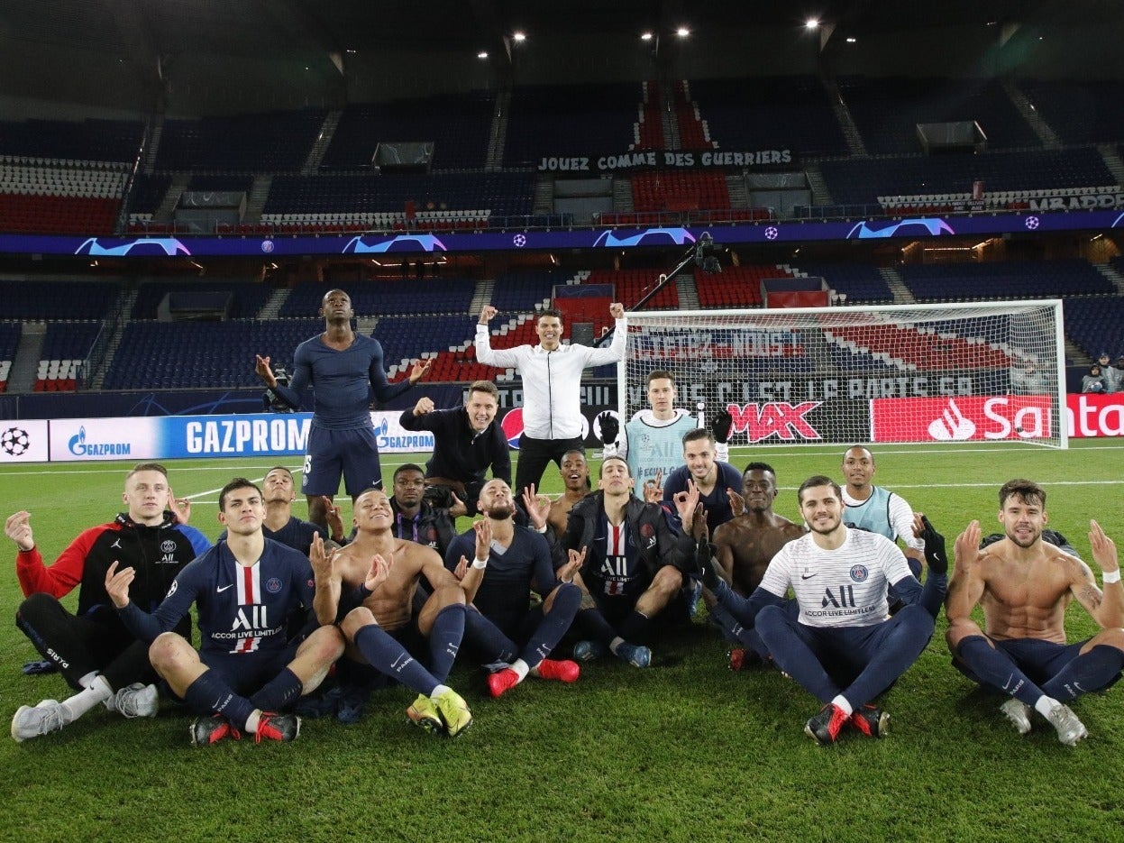 PSG celebrate at full-time in an empty stadium