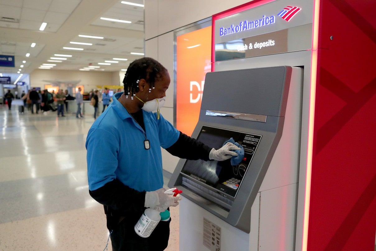 Hardy Williams works to disinfect areas of the international arrivals terminal at Dallas/Fort Worth International Airport on March 13 2020, the last day Europeans can fly into the US before a 30-day travel ban