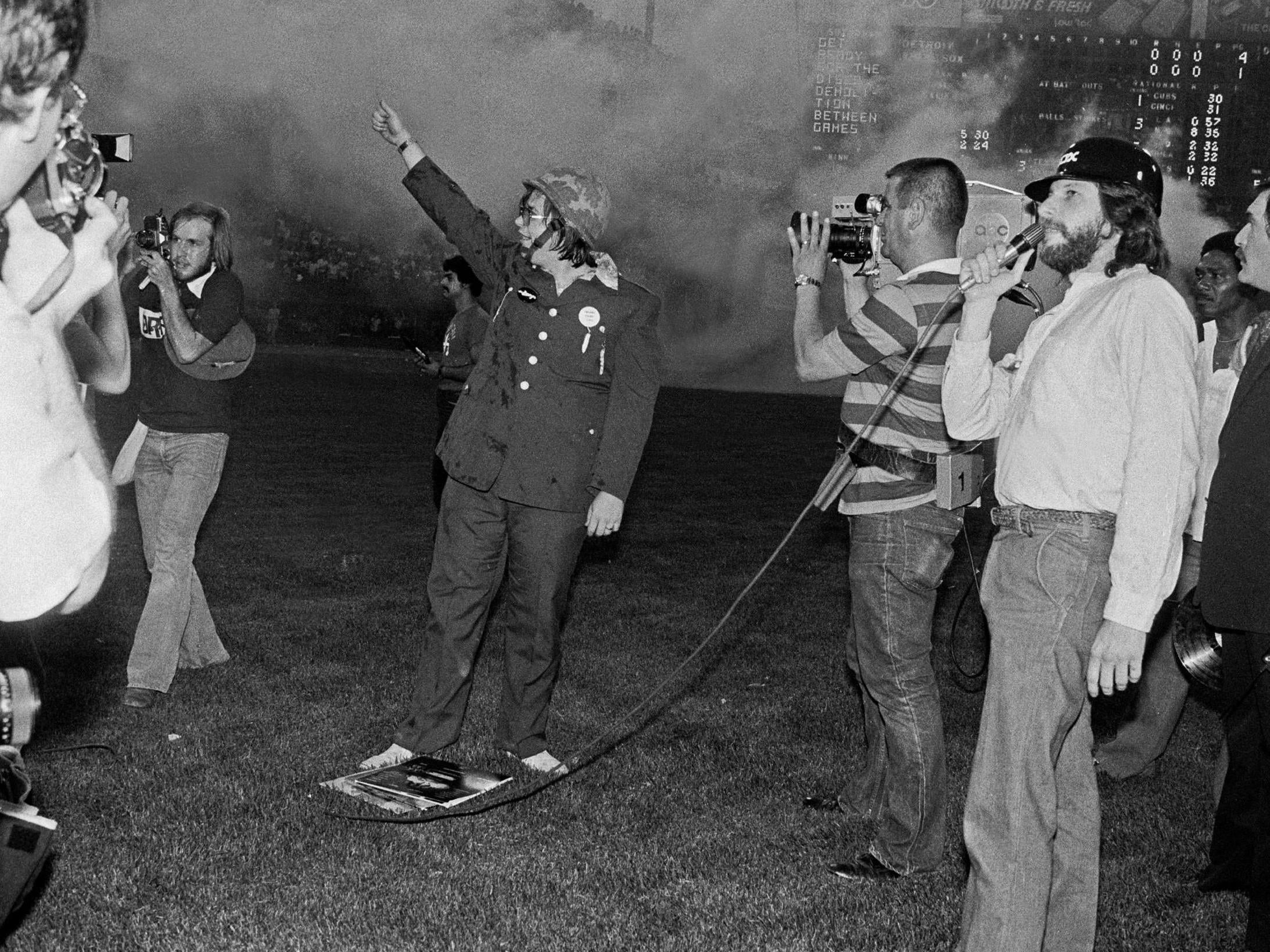 DJ Steve Dahl waves to the crowd during the anti-disco demonstration at Comiskey Park, Chicago