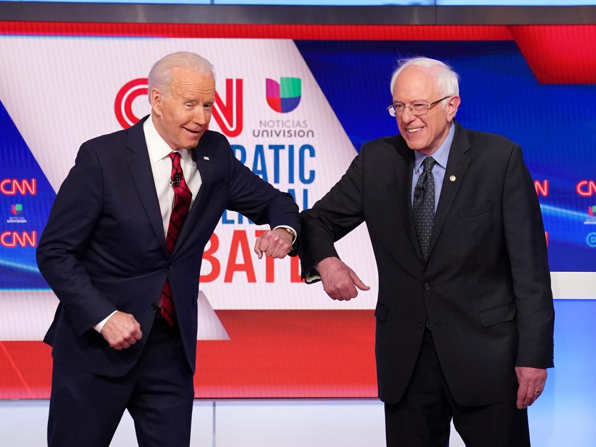 Joe Biden and Bernie Sanders bump elbows at the last debate during heightened social distancing recommendations due to the coronavirus