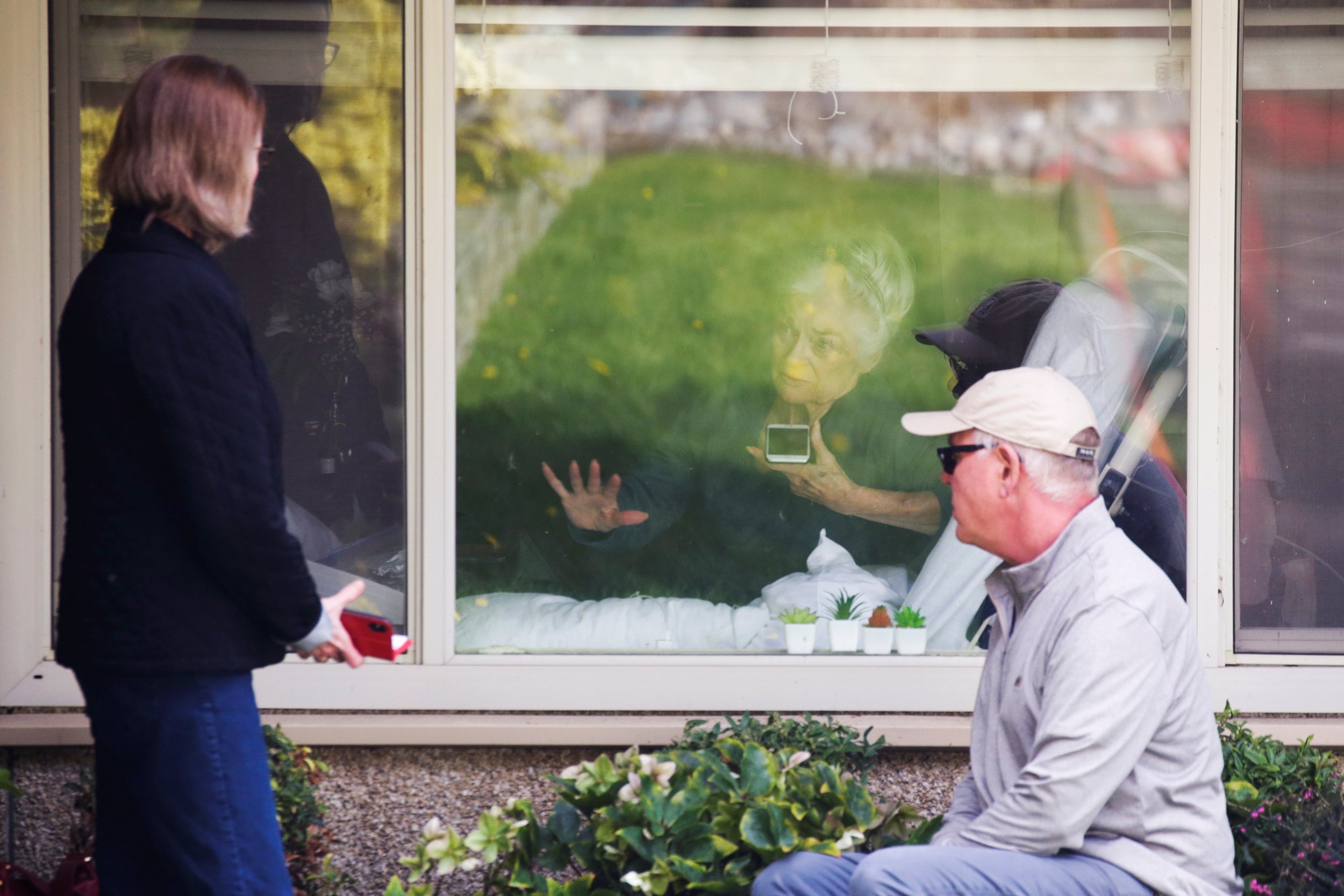 Residents at the Kirkland nursing home in Seattle were pictured communicating with their relatives through closed windows during the outbreak