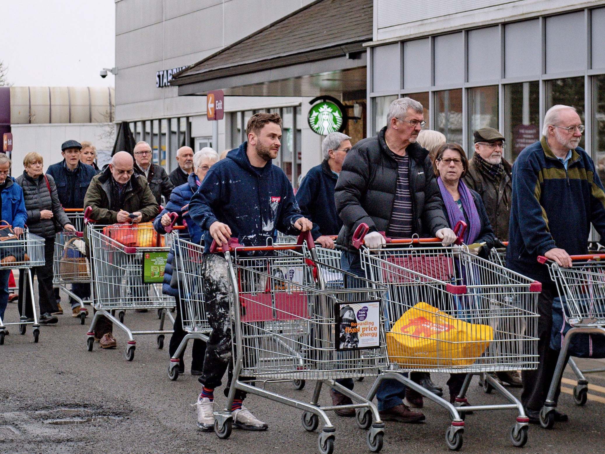 People queue outside Sainsbury’s in Leamington Spa, 19 March 2020