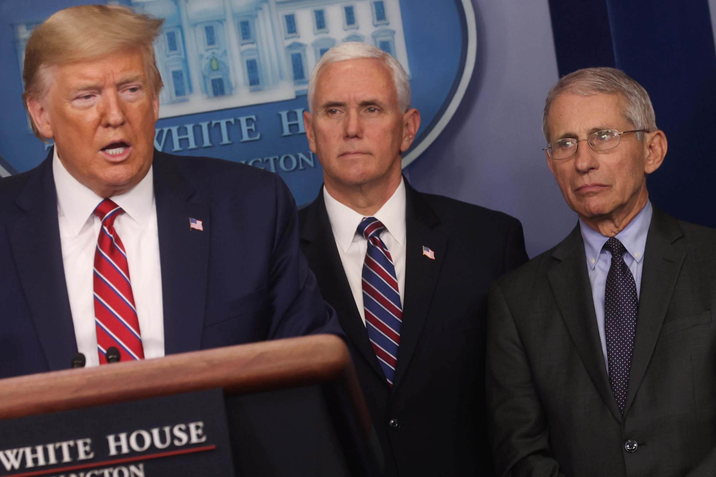 Dr Fauci and Mike Pence look on as Donald Trump leads a combative White House briefing, on 20 March 2020