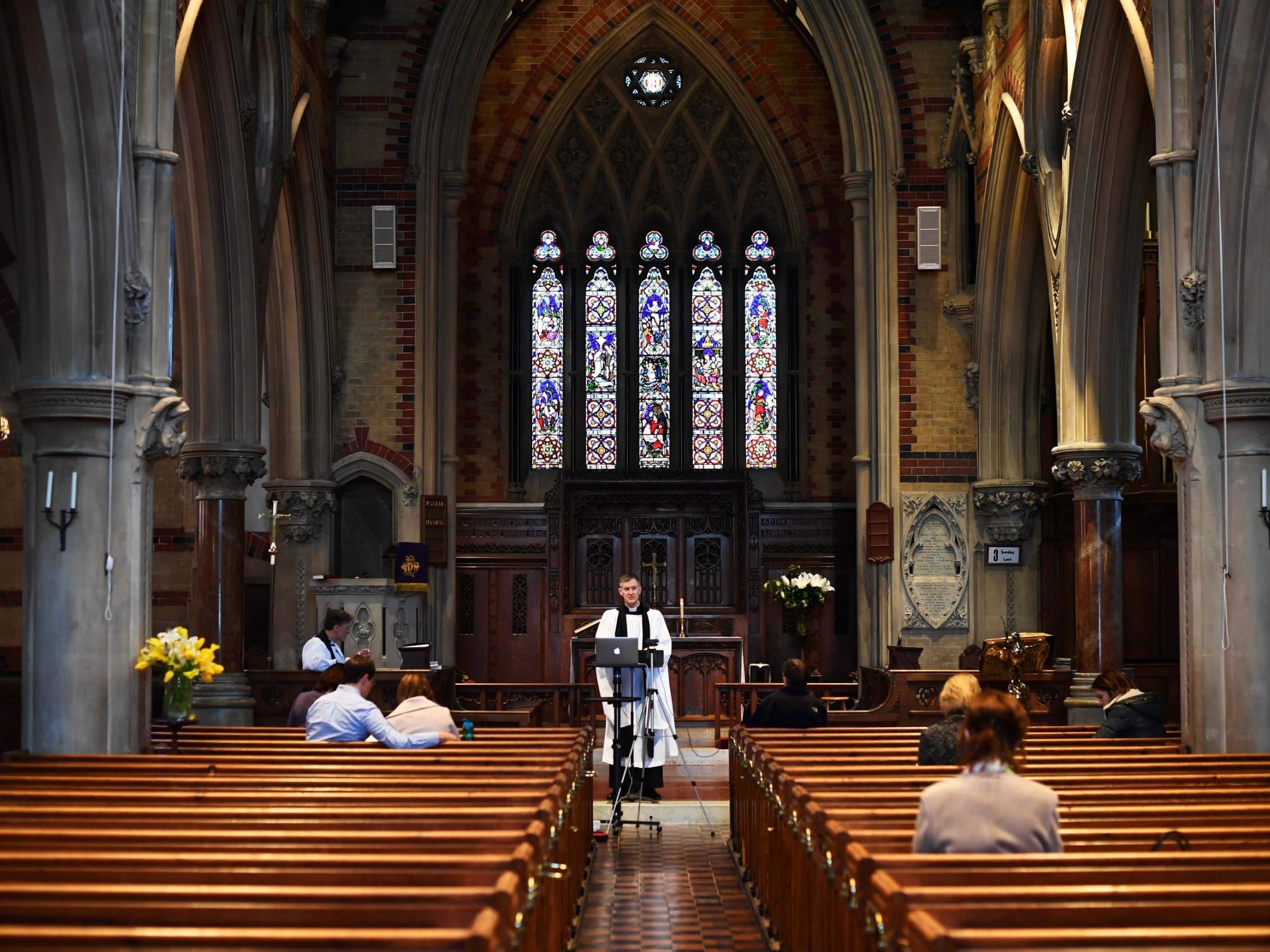 Curate Philip Stewart delivers his service via live stream and to a small congregation at Saint Simon Zelotes in London before the church closed its doors on Sunday night