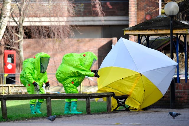 <p>A biohazard team place a tent over the bench where Yulia and Sergei Skripal where found in March 2018</p>