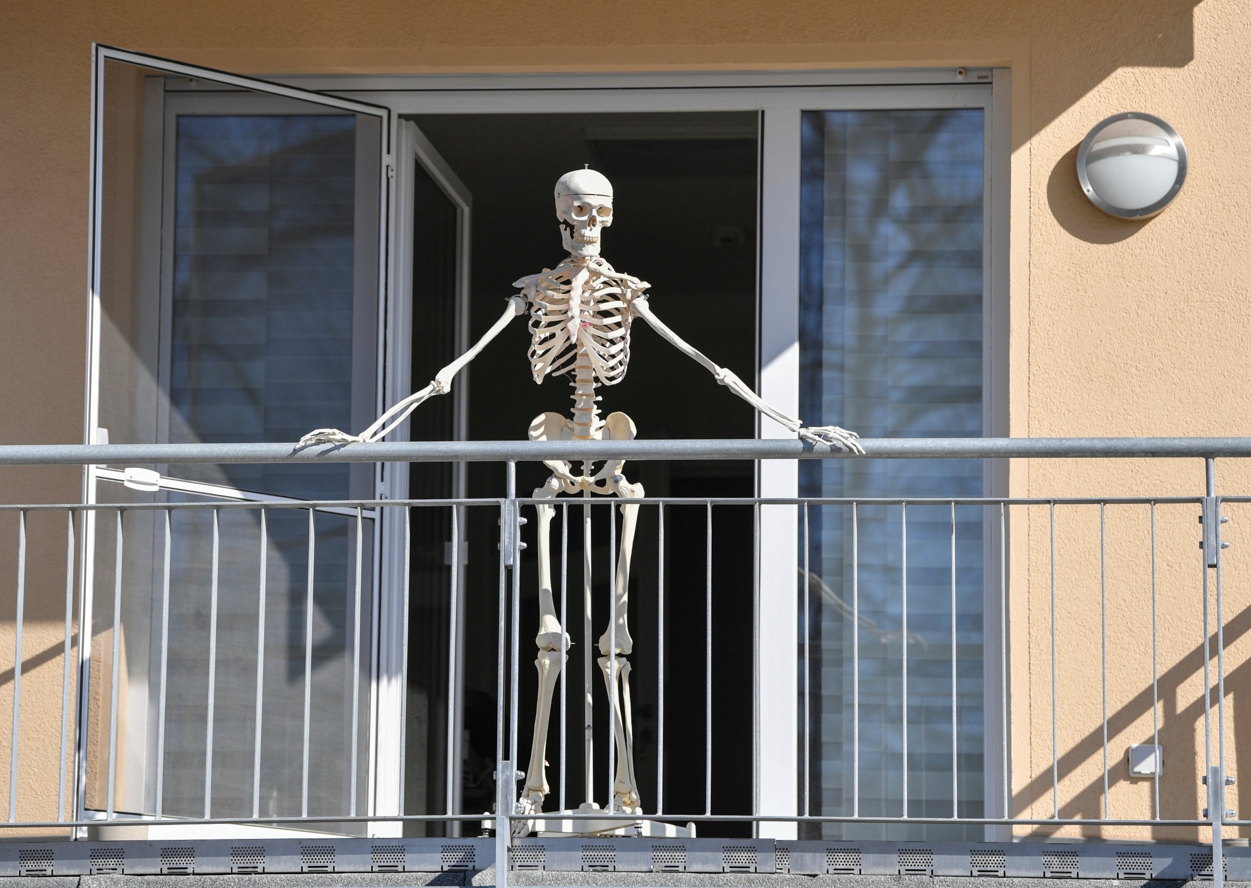 A skeleton stands on a balcony in Frankfurt, Germany