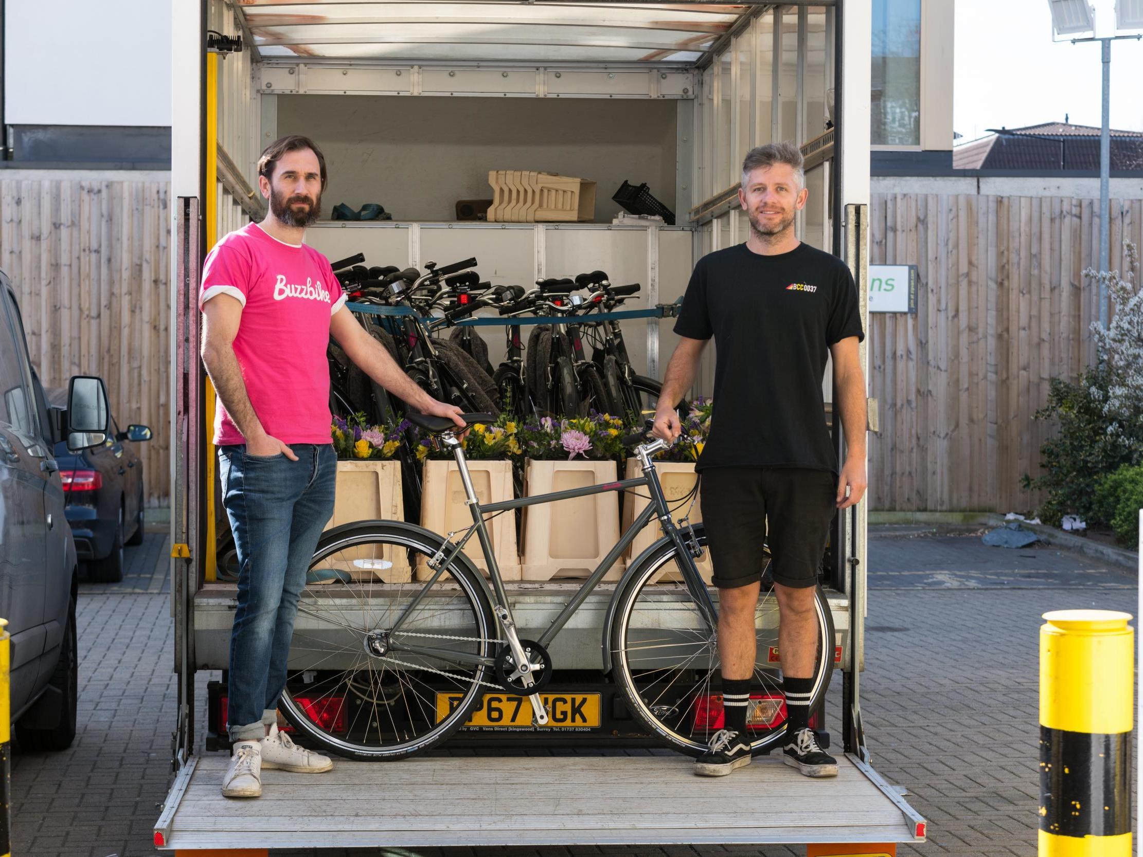 Tom Hares (left), CEO of Buzzbike, and Steve Coombes, a mechanic, dropping off bikes to NHS workers in London