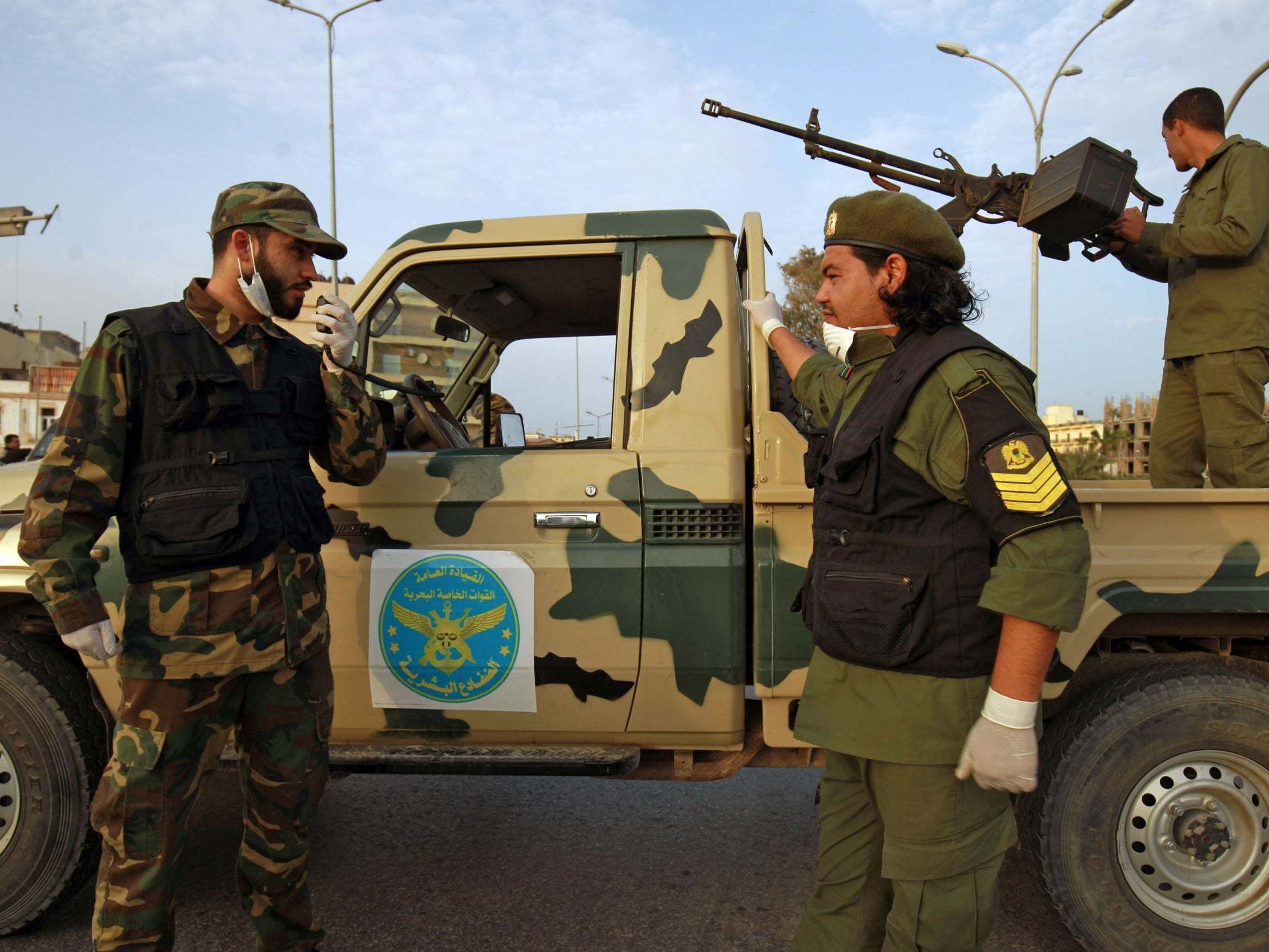 Fighters of a military battalion loyal to Libyan General Khalifa Hafta patrol the streets in the eastern city of Benghazi