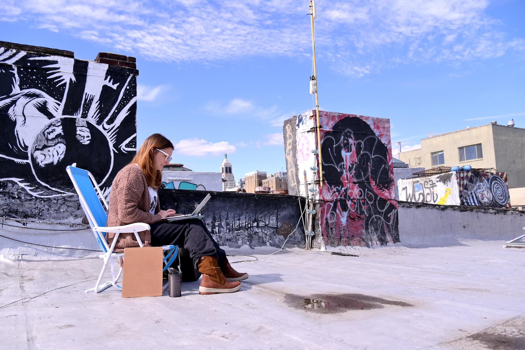 A teacher from Yung Wing School P.S. 124 who wished not be identified remote teaches on her laptop from her roof on March 24, 2020 in New York City