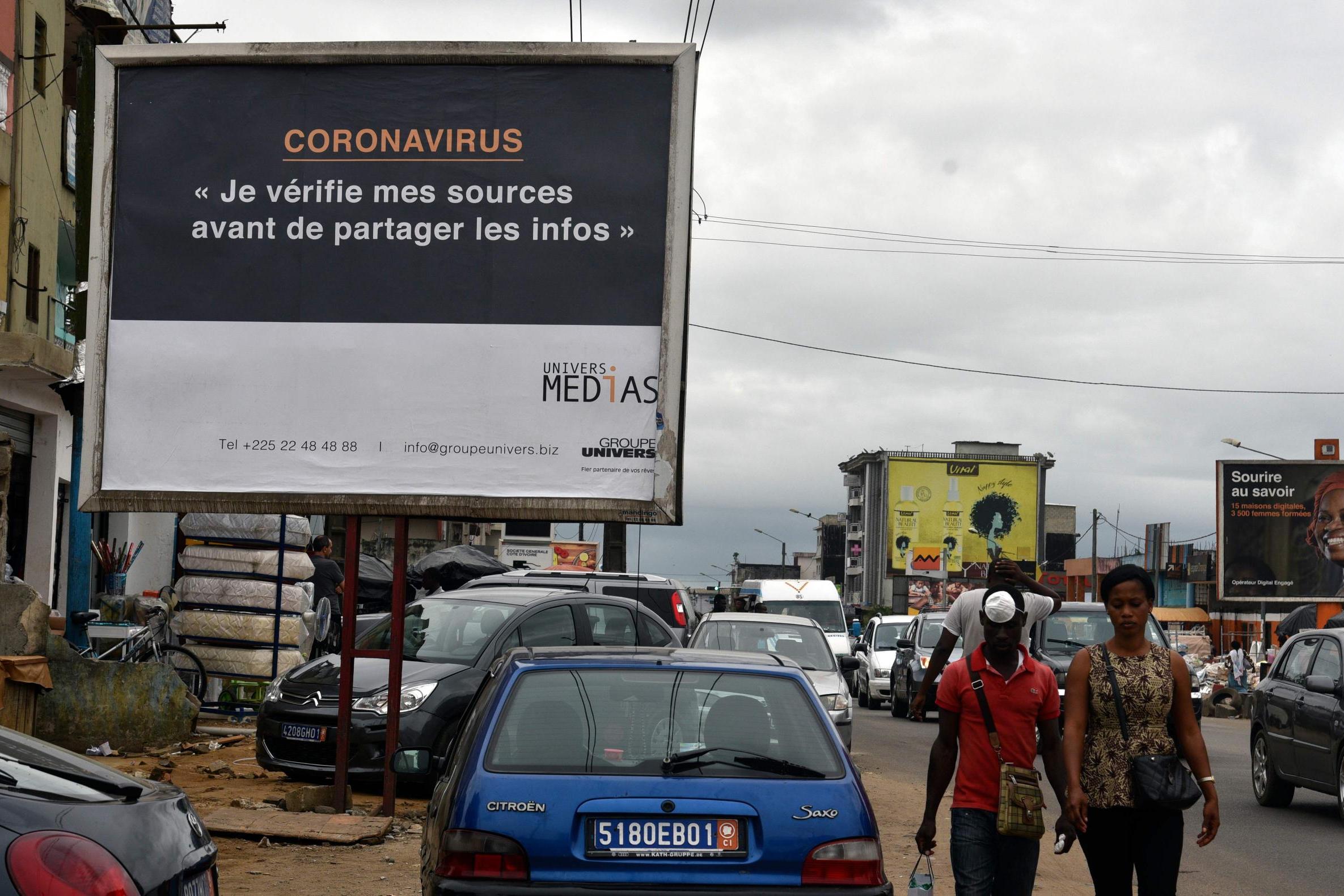 ‘Coronavirus – I check my sources before sharing news’ is the warning to people about fake news in Abidjan, Ivory Coast (AFP/Getty)