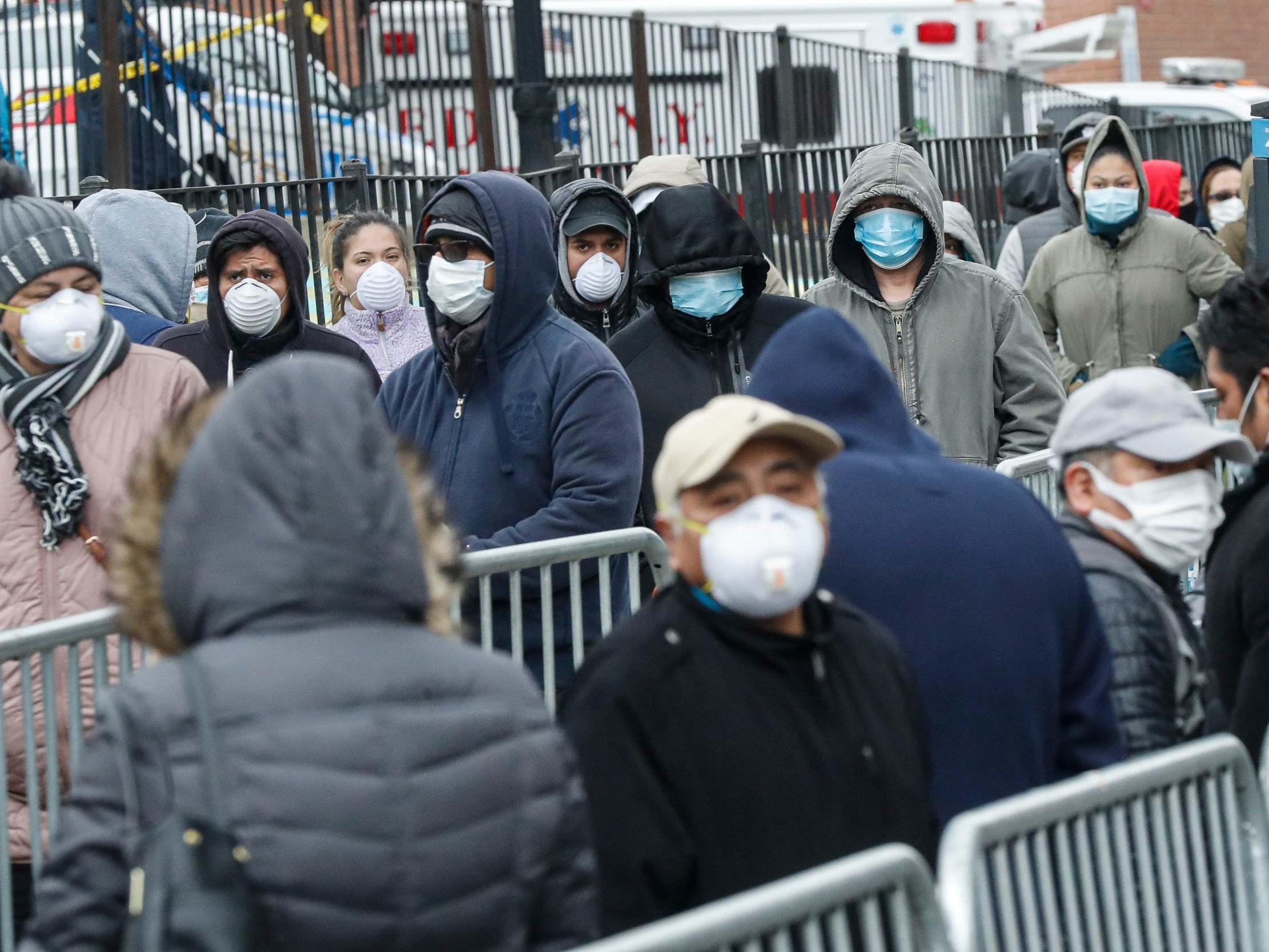 New Yorkers in the borough of Queens queue at Elmhurst hospital for coronavirus tests, as 13 deaths are reported in one day