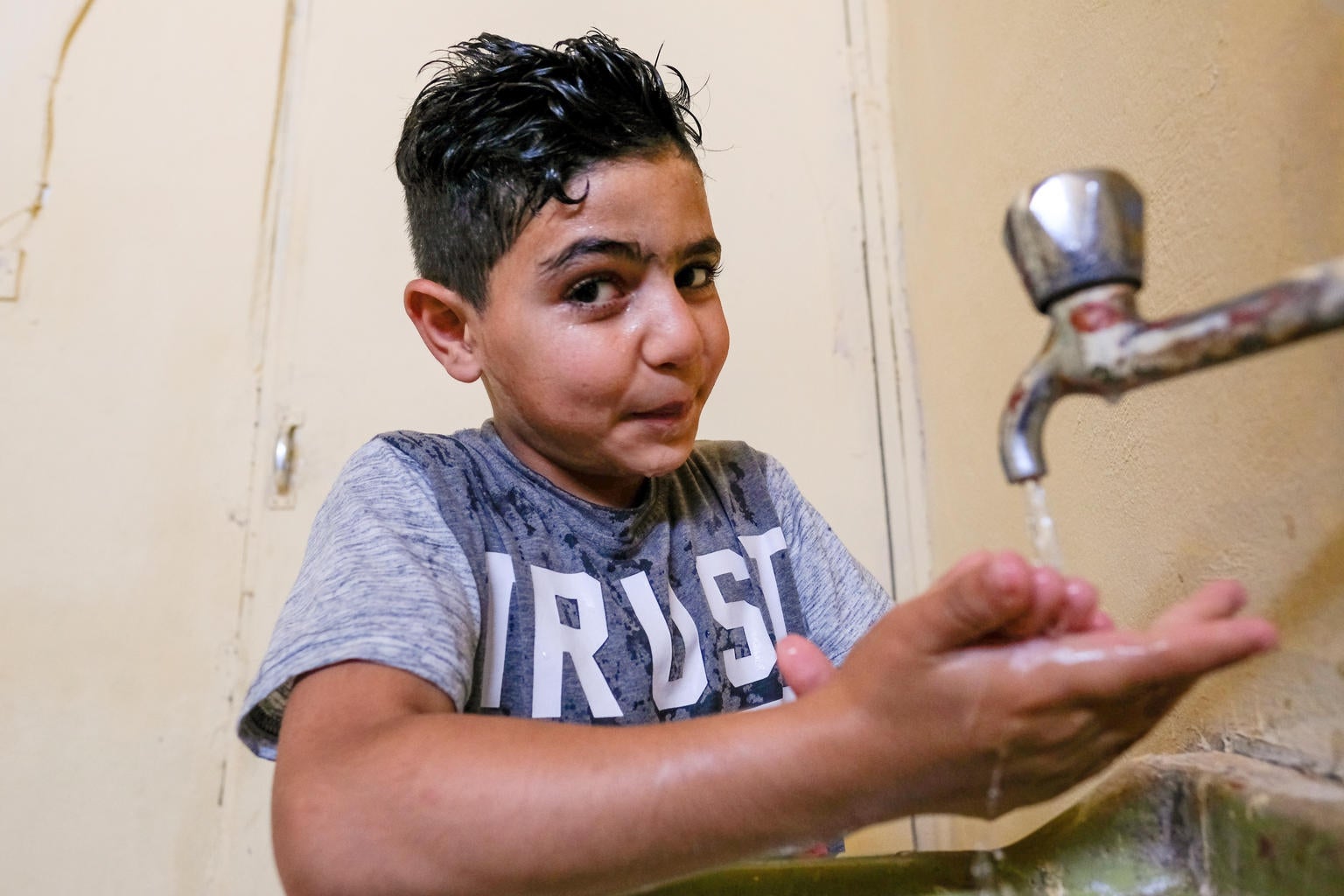 Despite major issues of water scarcity in Jordan, Mahmoud is able to wash his hands and face using a storage tank provided by Unicef. He lives in the Baqa’a camp with his parents, brother and sister. The family are refugees from the Palestinian territories