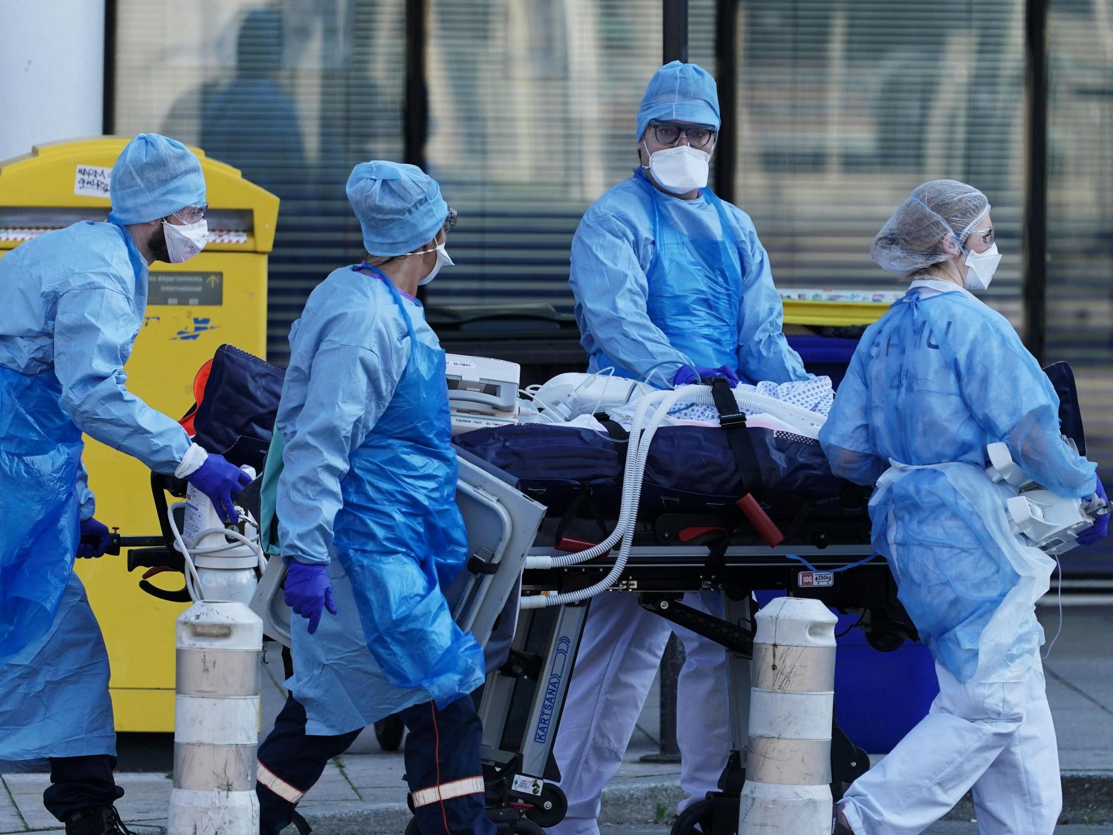 Medical staff move a patient from a train from Strasbourg to an ambulance