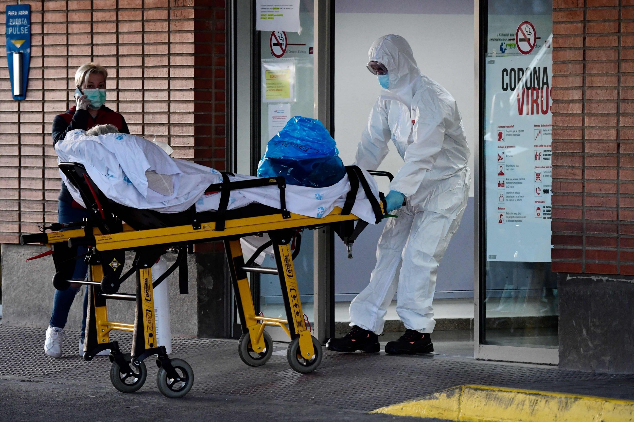 A health worker transfers a patient on a stretcher at the Severo Ochoa hospital in Leganes, Spain