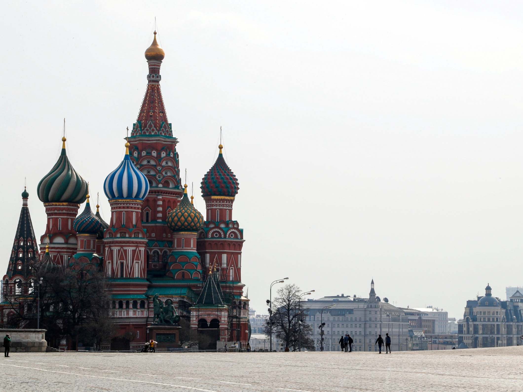 People walk near the cathedral of Vasily the Blessed on the Red Square in Moscow, Russia, after authorities ordered a lockdown