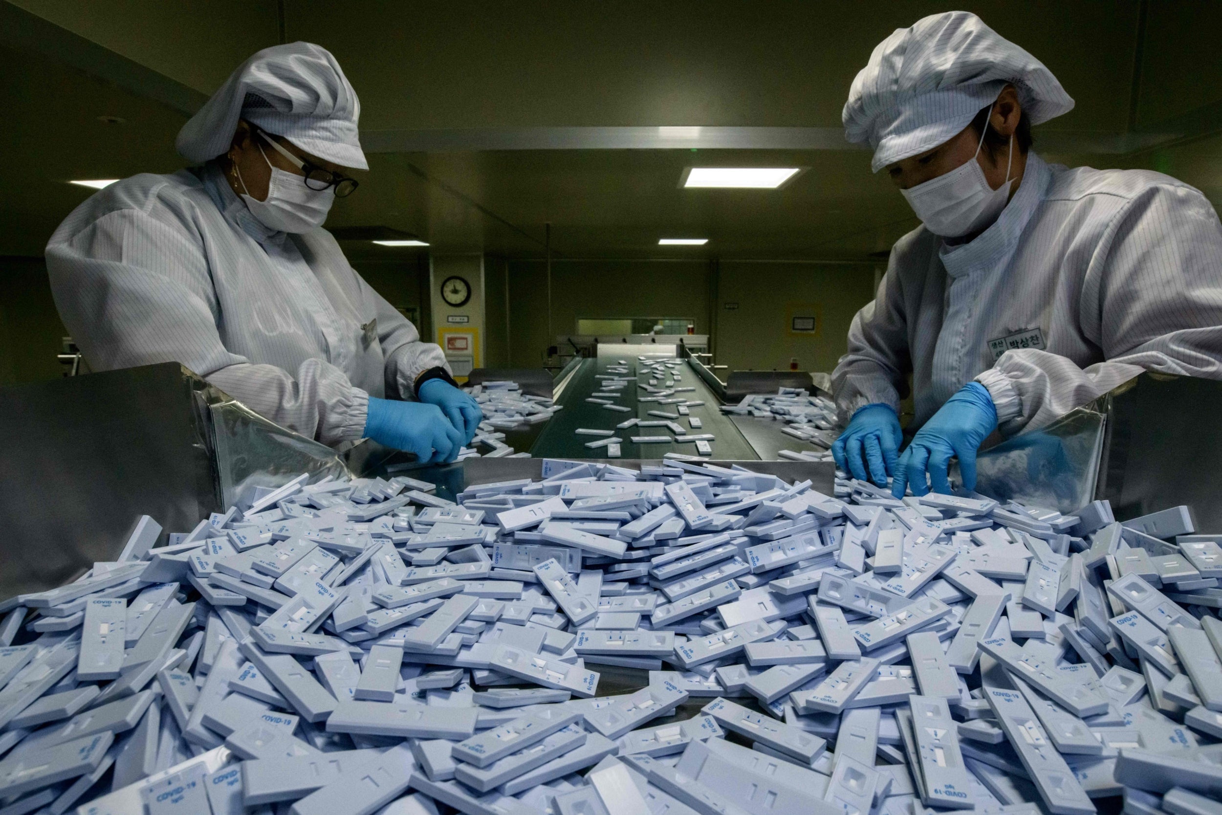 Sample testing devices are checked on a production line in Seoul (AFP/Getty)