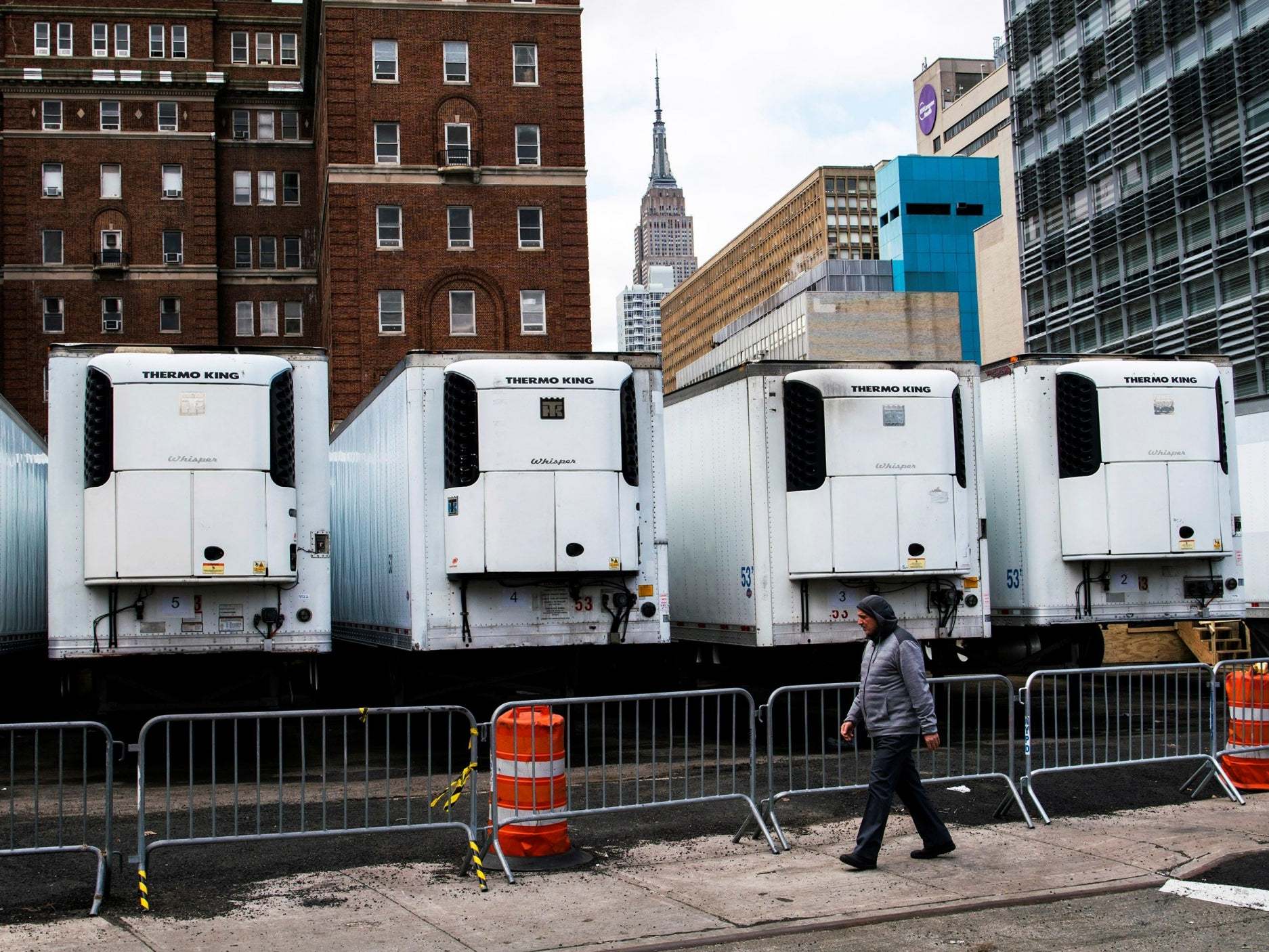 Refrigeration units used as morgues in New York, where deaths in the state account for 40% of the US total