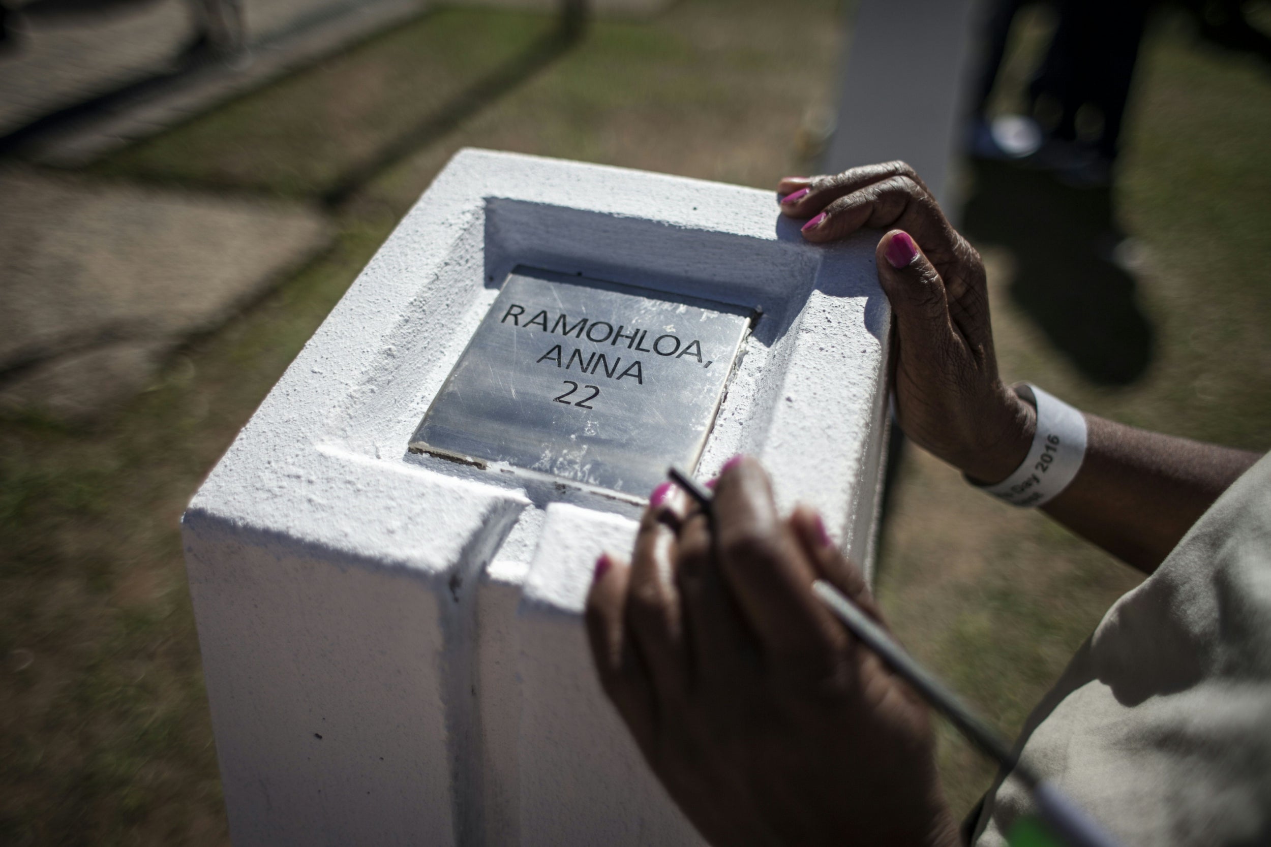 A family member stands next to a memorial to one of the victims of the Sharpeville massacre ahead of Human Rights Day in 2016 (AFP/Getty)