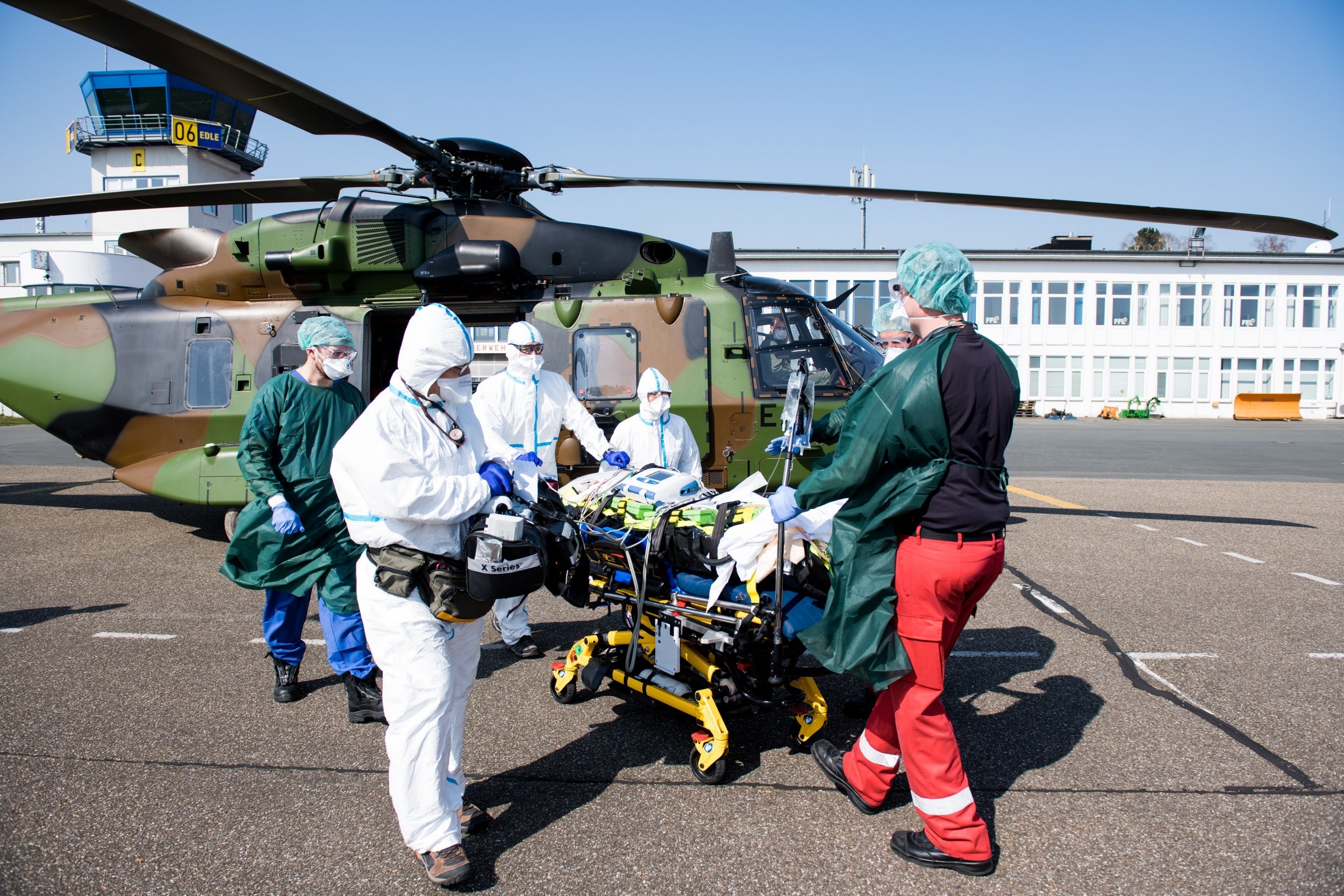 Staff take care of Covid-19 patients arriving from France at the airport in Essen, Germany