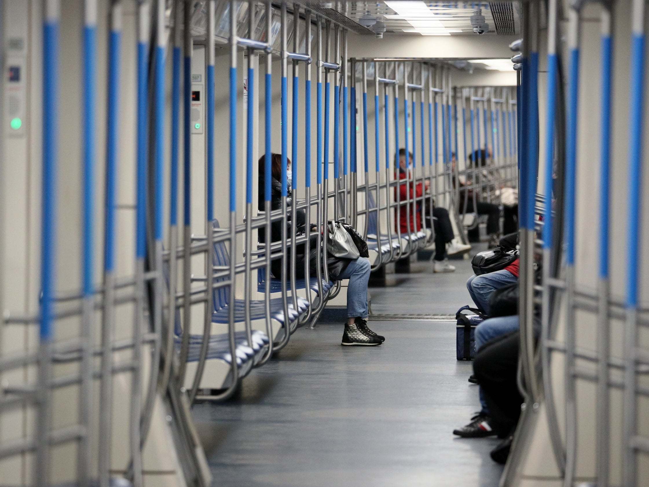Plenty of space: Muscovites in face masks on the metro yesterday (Tass)