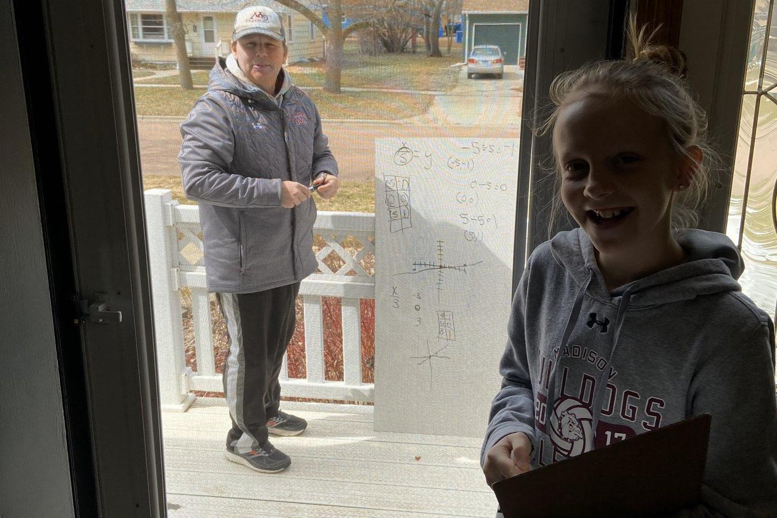 Math teacher shows up with whiteboard to help student while social distancing (Josh Anderson)