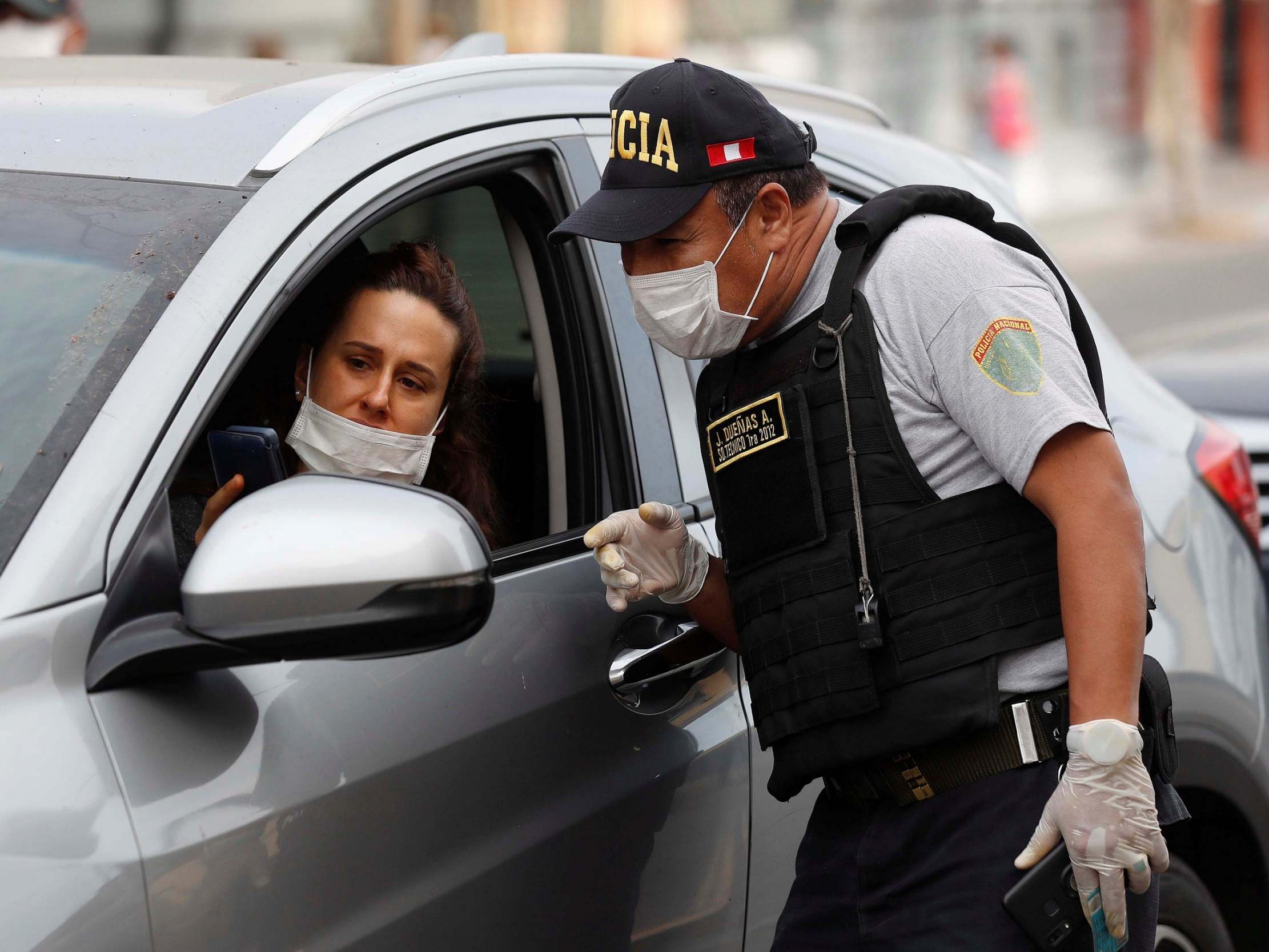 A policeman controls the circulation of people authorized to transit in Lima, Peru