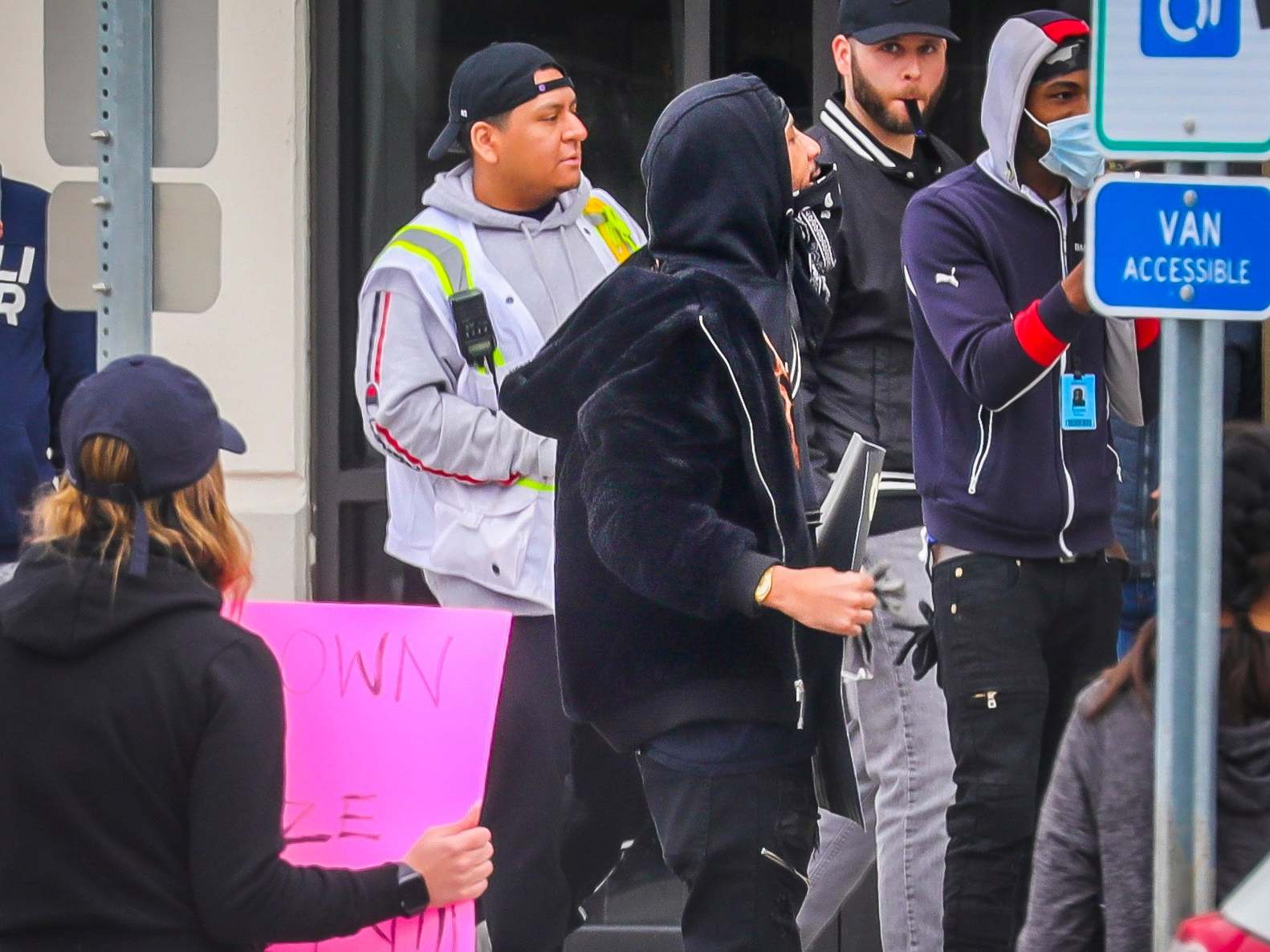 Chris Smalls (pictured centre) led Amazon workers on a walkout