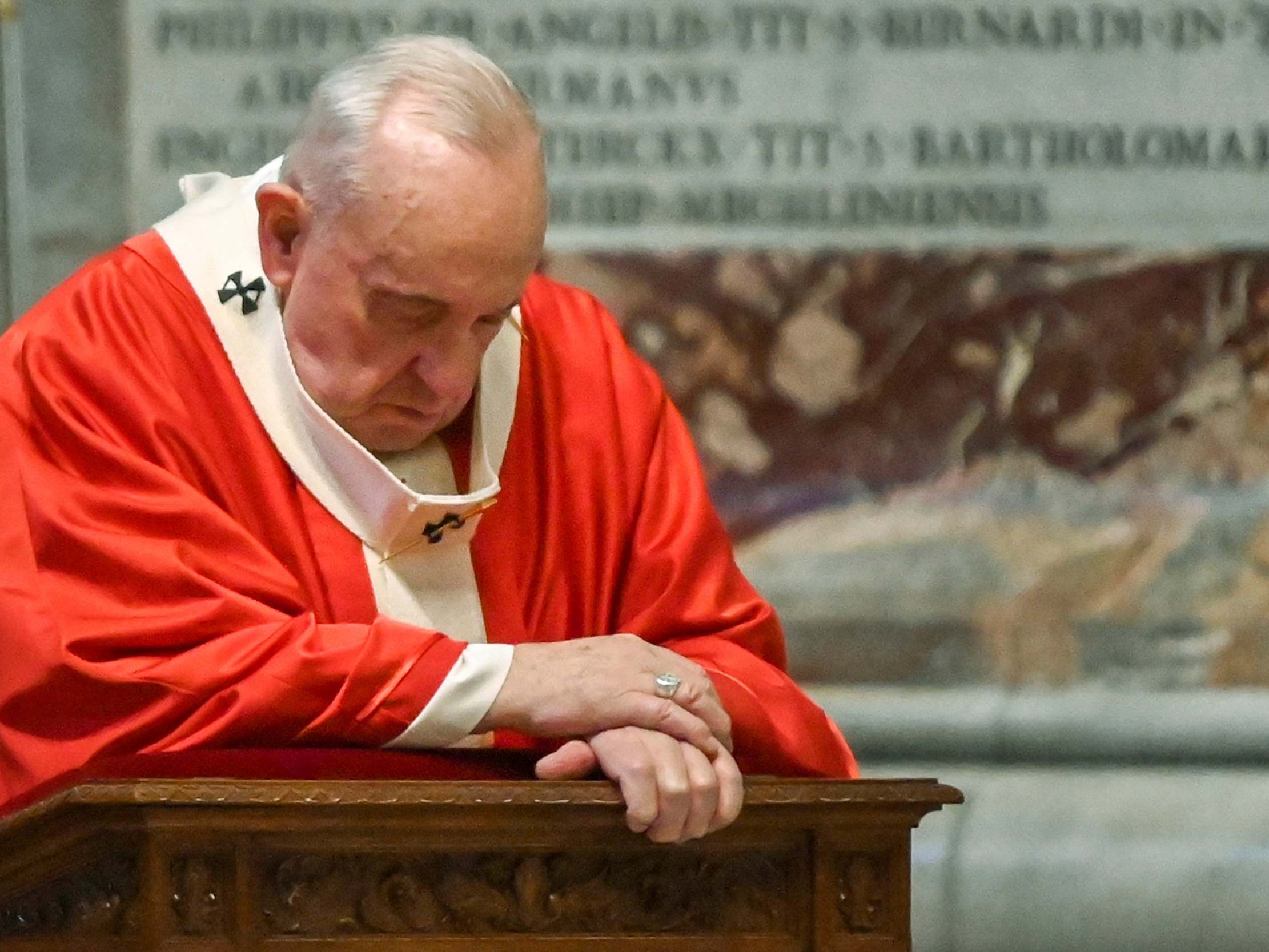 Pope Francis prays as he celebrates Palm Sunday Mass behind closed doors