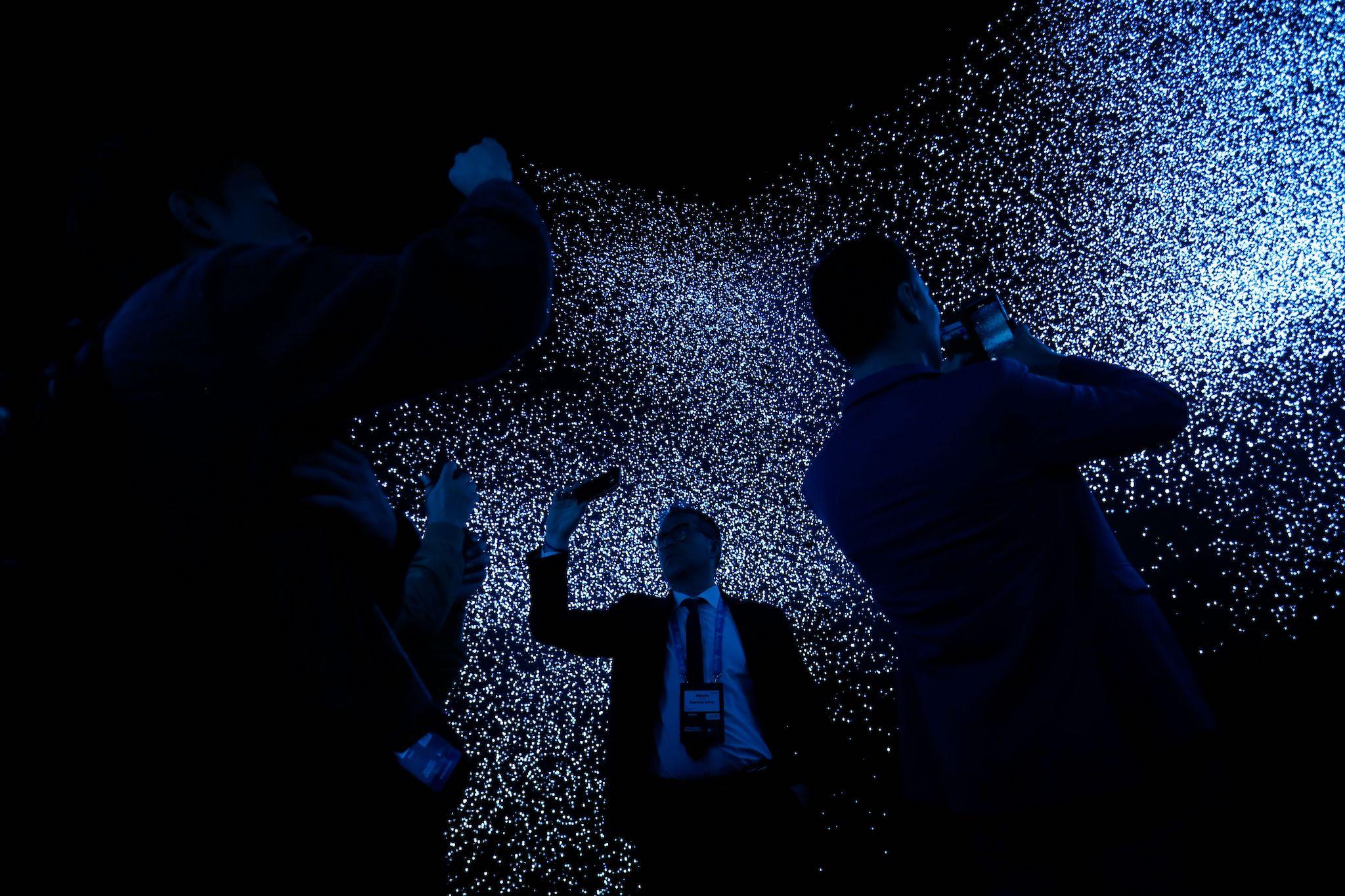 People visit the Qualcomm stand at the Mobile World Congress (MWC) in Barcelona on February 26, 2019