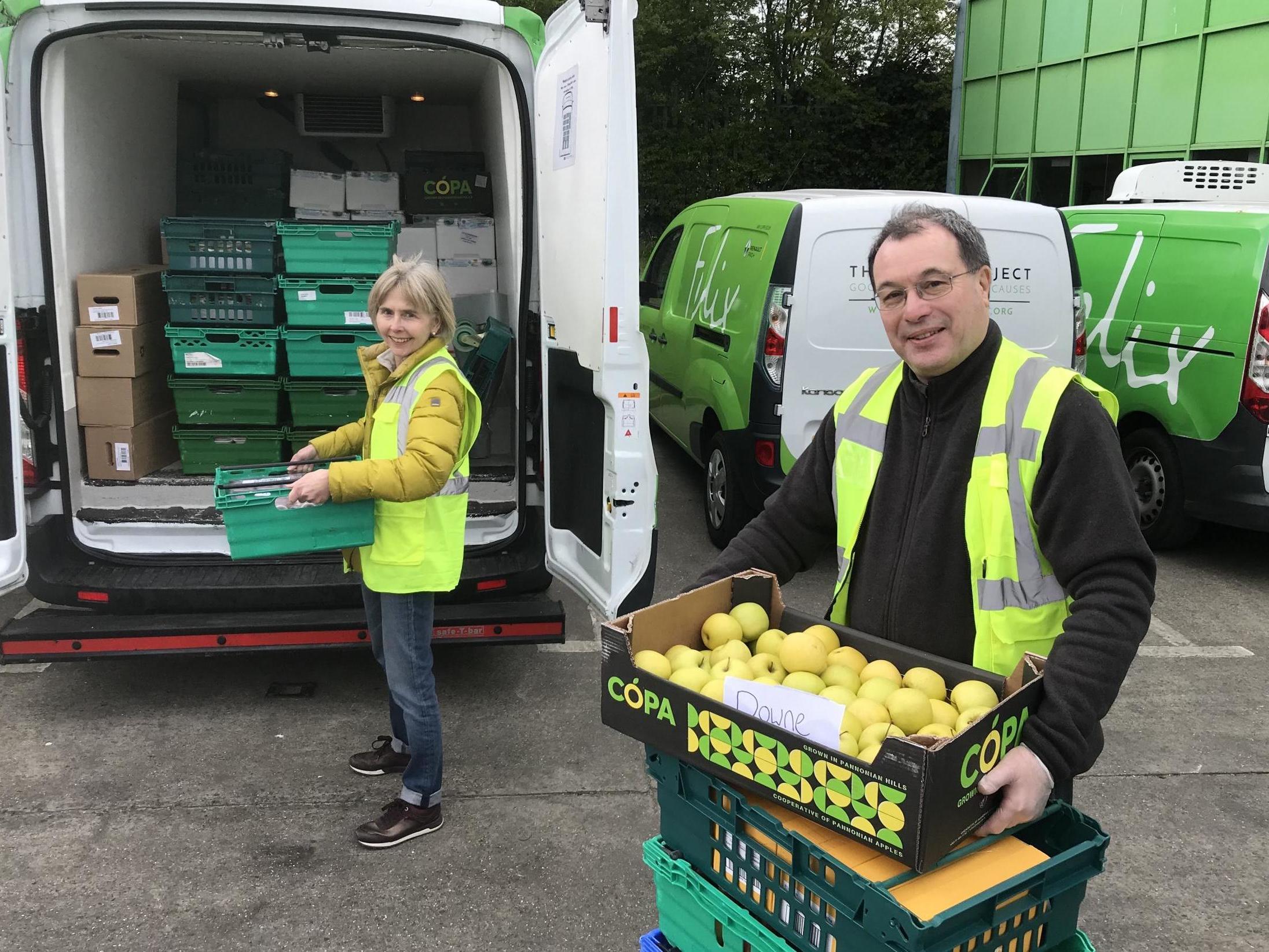 Wife and husband volunteer team Liz and Graham Taylor, packing Felix Project vans (The Independent )