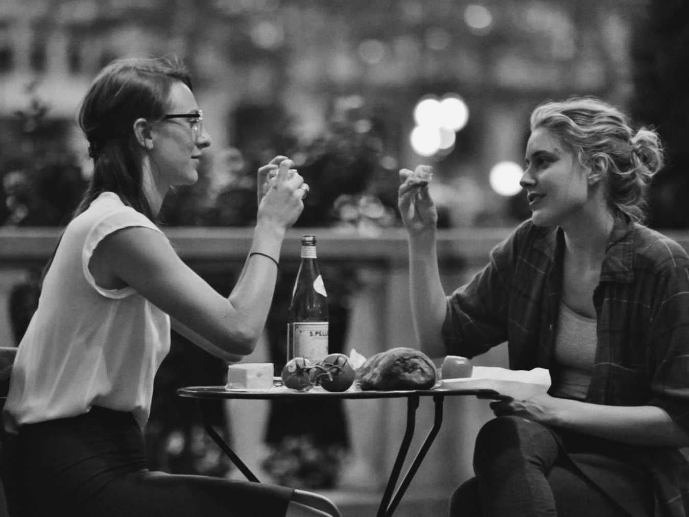 Sophie (Mickey Sumner) and Frances (Greta Gerwig) eat dinner together after work in Frances Ha.