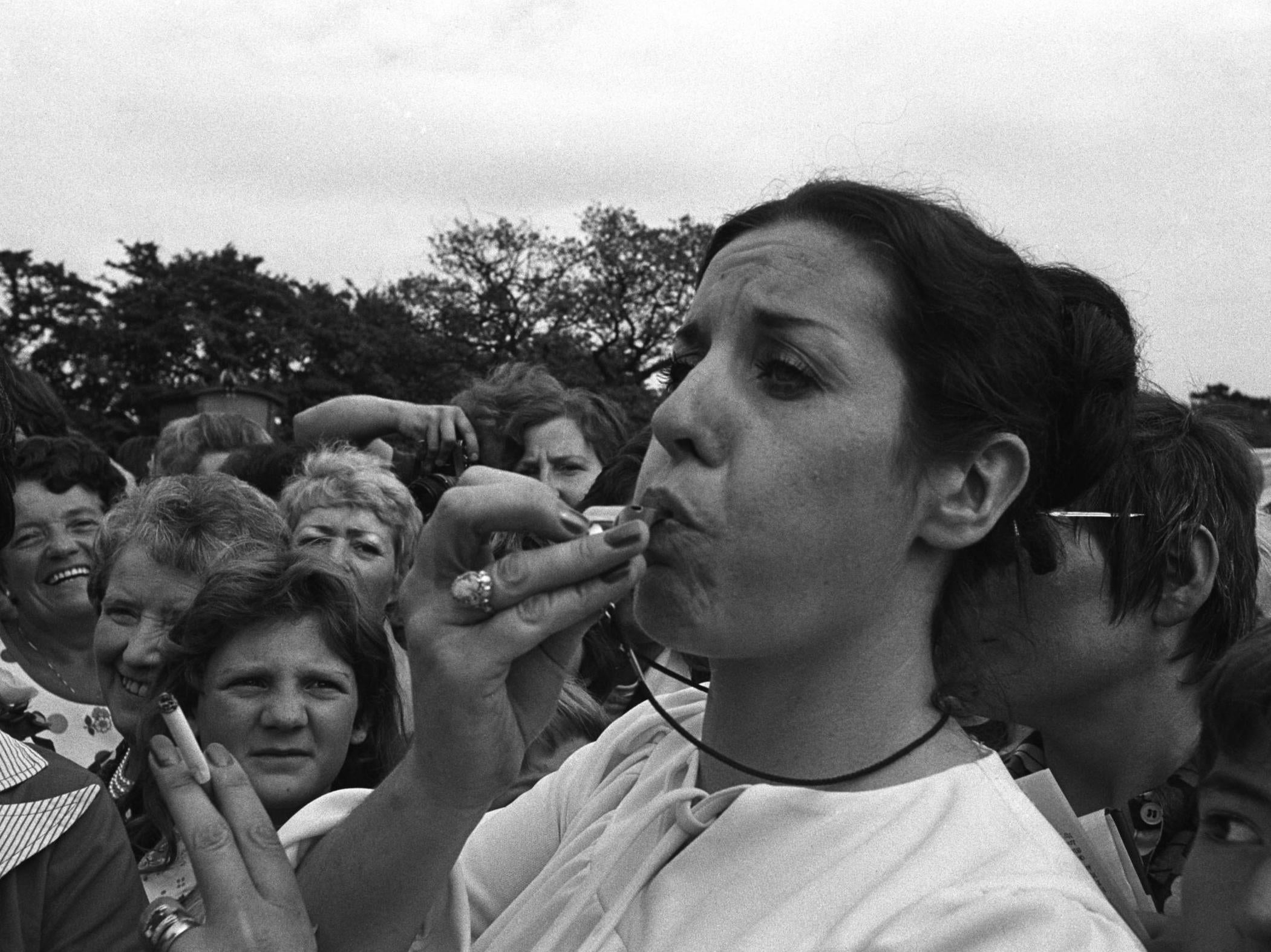 Williams blows a whistle for peace at a Belfast rally in 1976