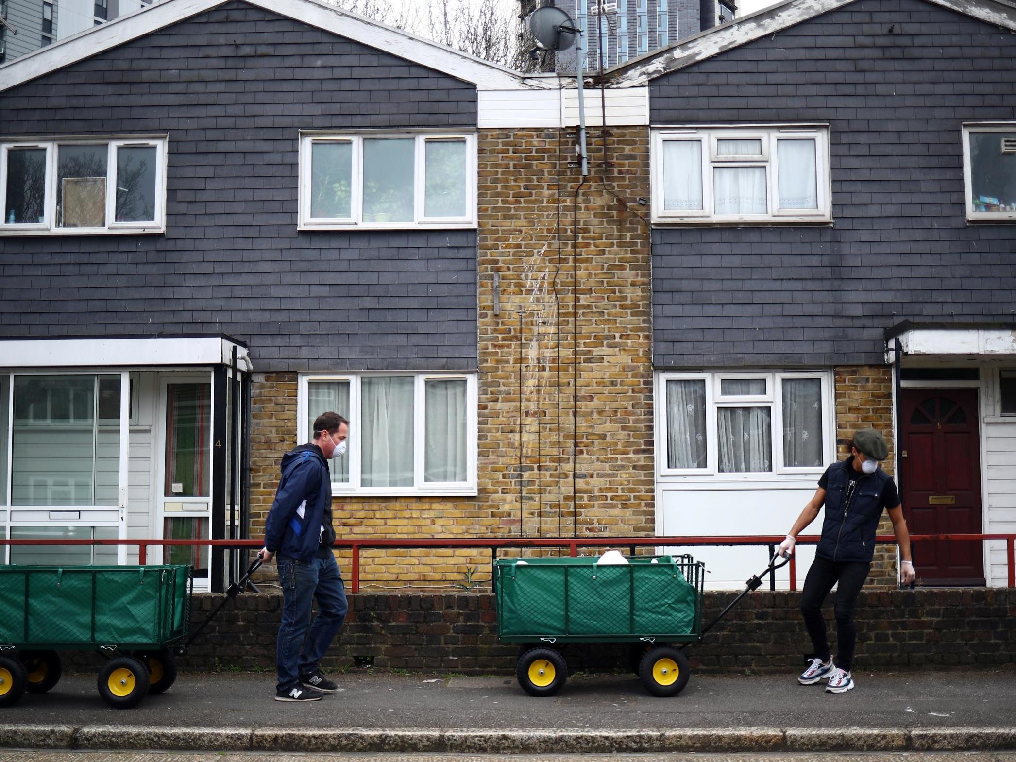 Volunteers drop off donations from a local food bank door-to-door in Stratford