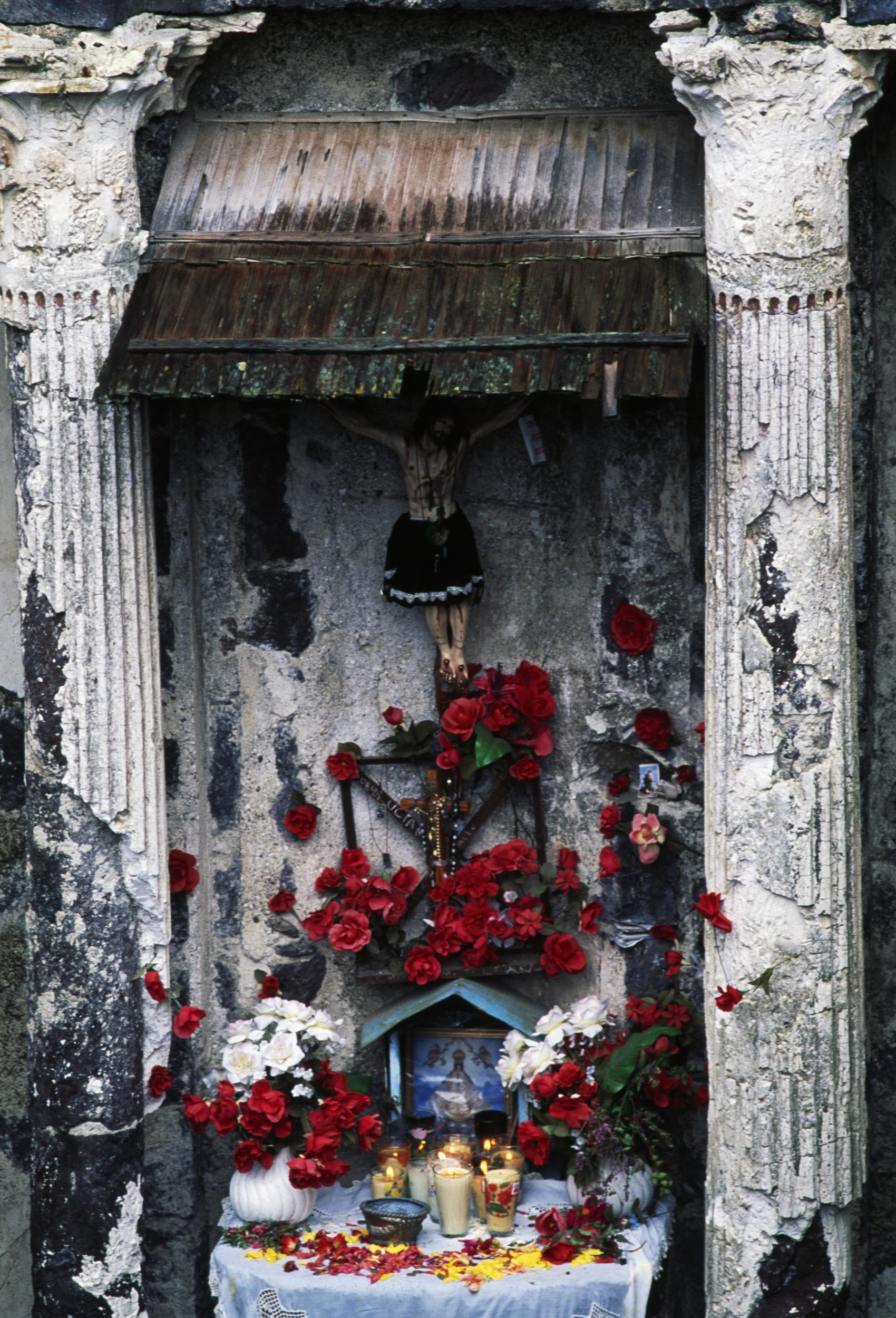 Flowers and candles on an altar in the Church of San Juan in Parangaricutiro