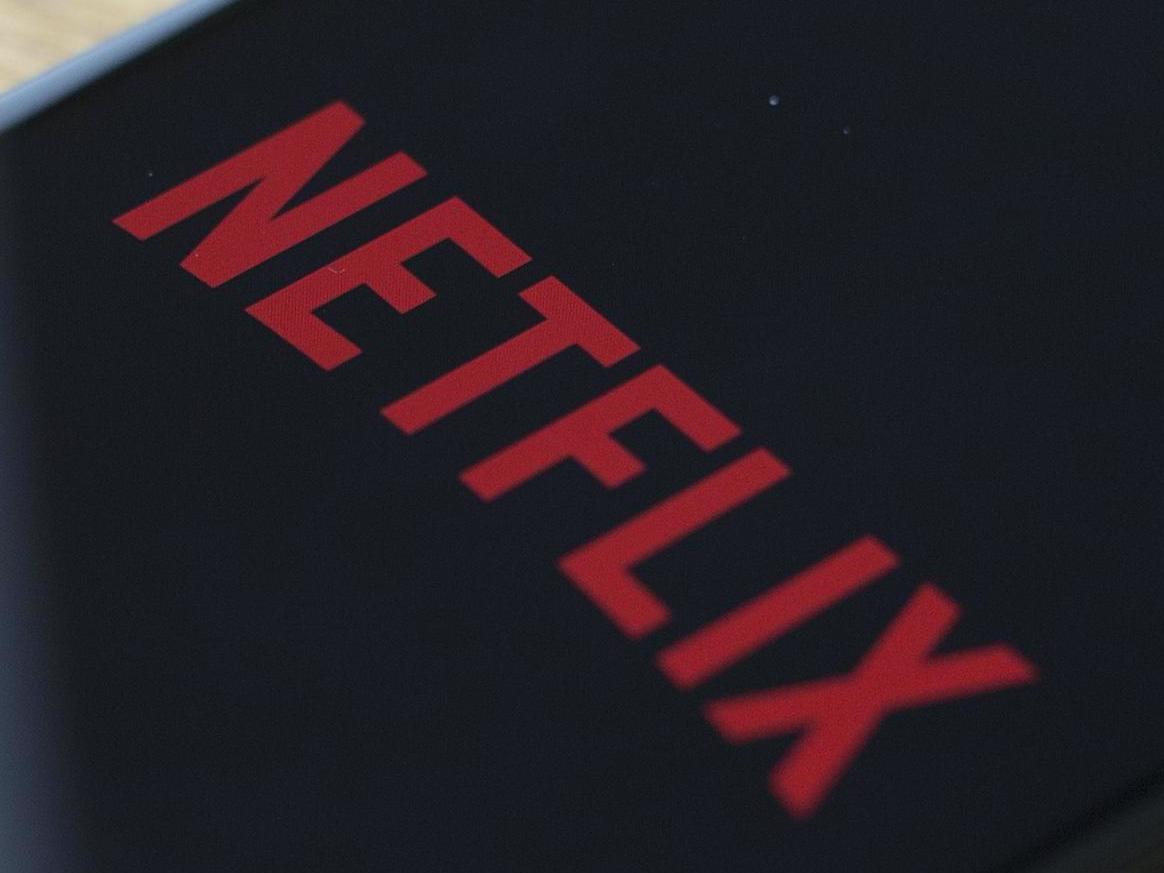 The Netflix logo is seen on a phone in this photo illustration in Washington, DC, on July 10, 2019