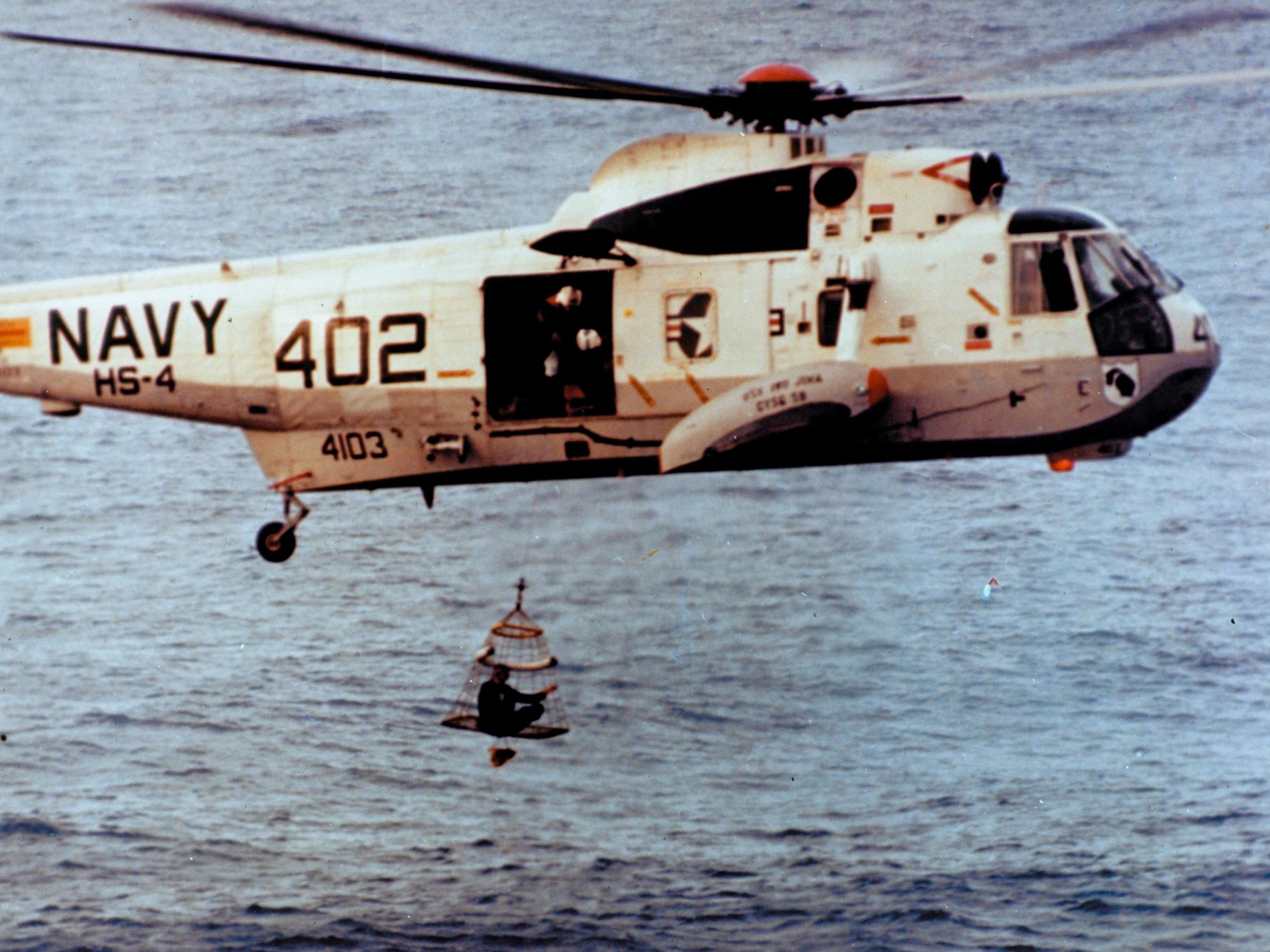An astronaut is winched to safety by helicopter during the Apollo 13 recovery operations