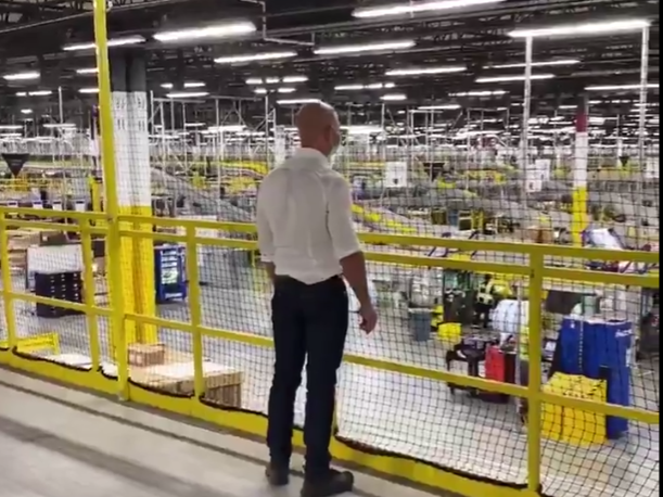 Amazon founder and CEO Jeff Bezos observes workers in a US warehouse (Amazon, Twitter)