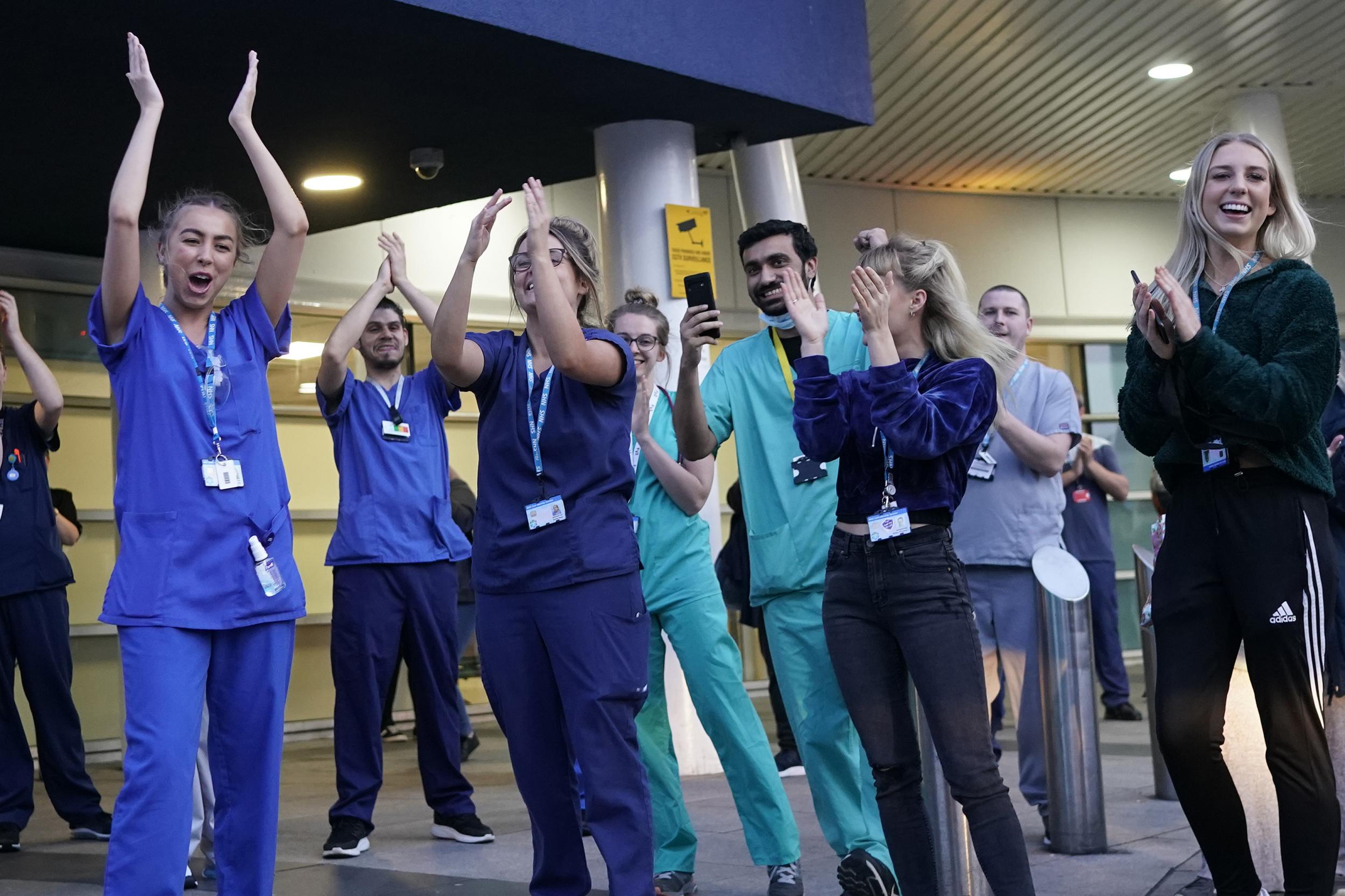 NHS staff applaud themselves and their colleagues at the entrance of the Royal Liverpool Hospital