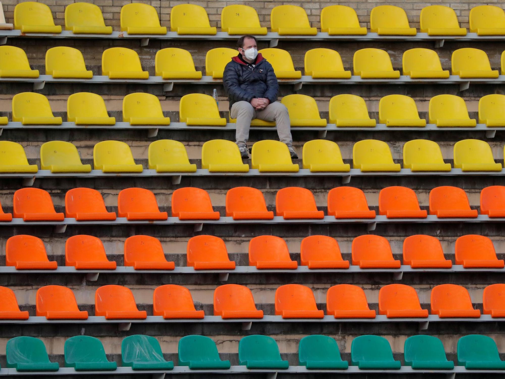 A fan sits alone in the stands at FC Neman vs Belshina
