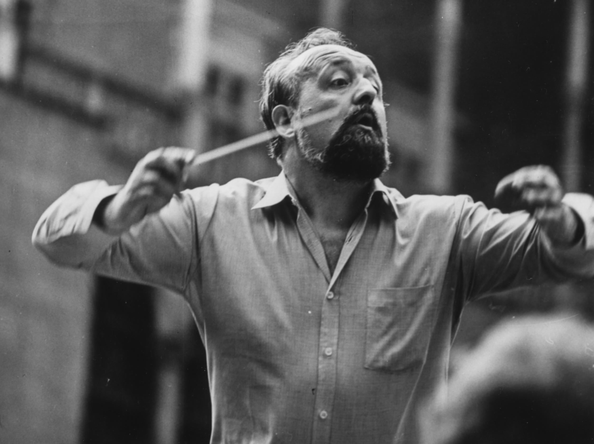 The composer conducts an orchestra in 1980