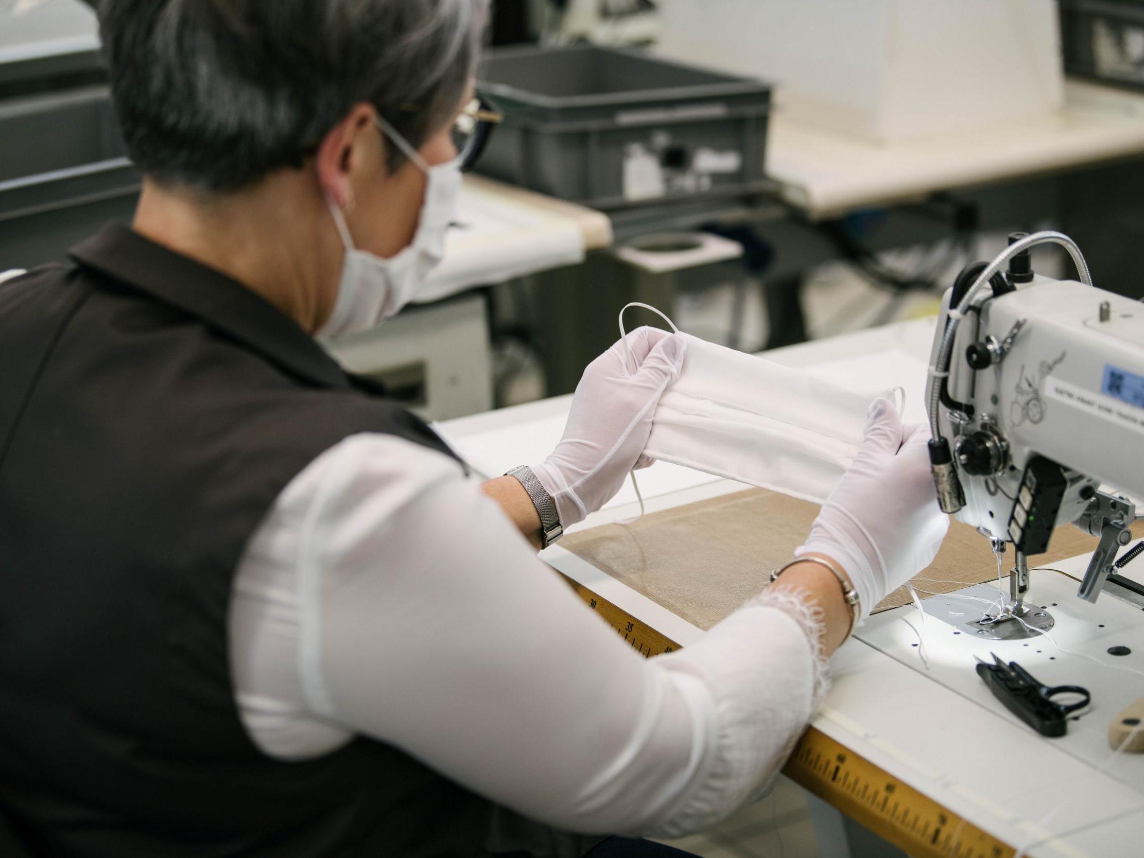 An employee tailors PPE masks at Louis Vuitton workshop in Paris, France on 10 April 2020